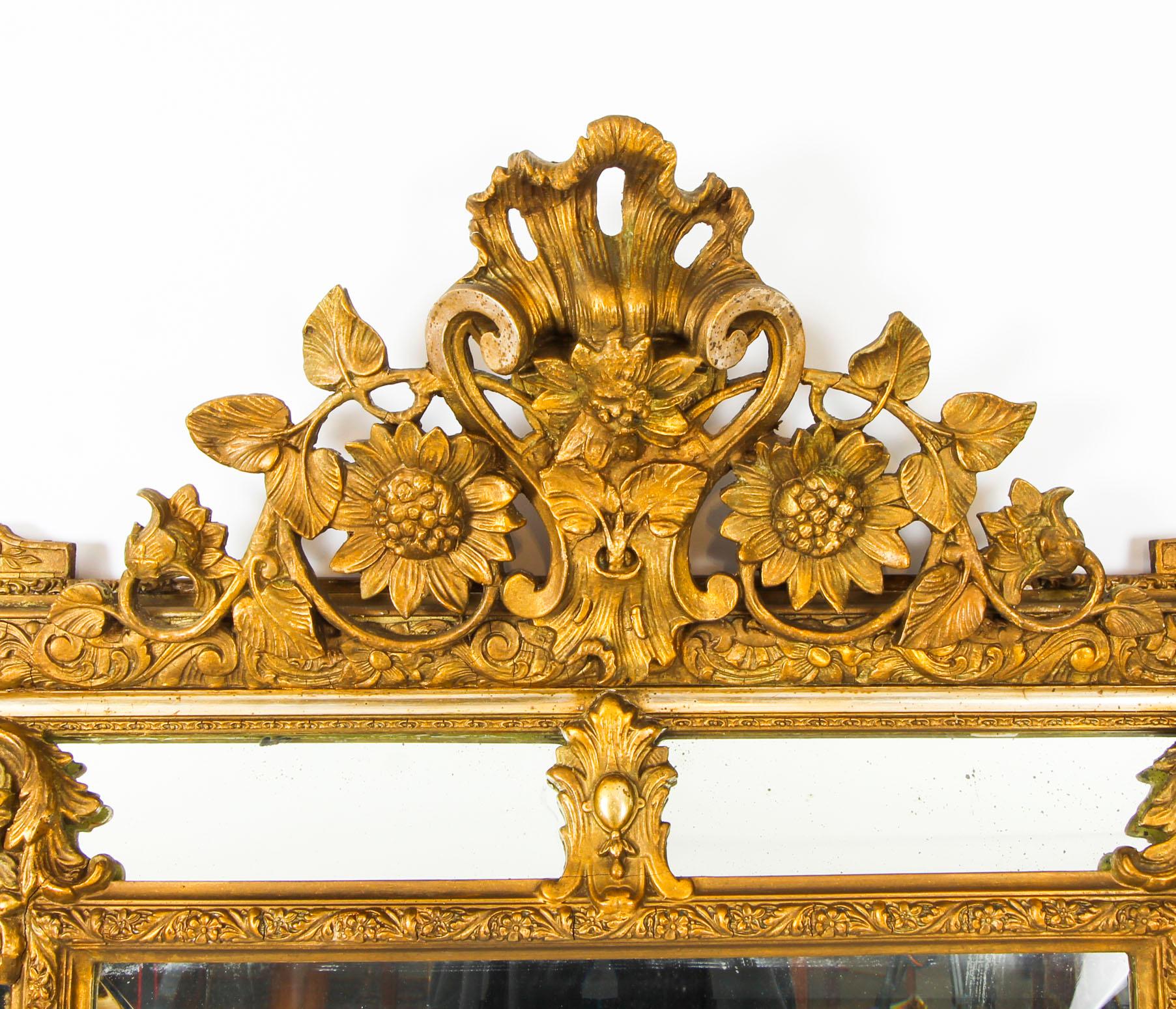 This is a magnificent antique French Louis Revival giltwood overmantle mirror, circa 1860 in date.

The bevelled rectangular mirror plate is framed with marginal side plates. It has a profusely carved giltwood frame decorated with acanthus leaves