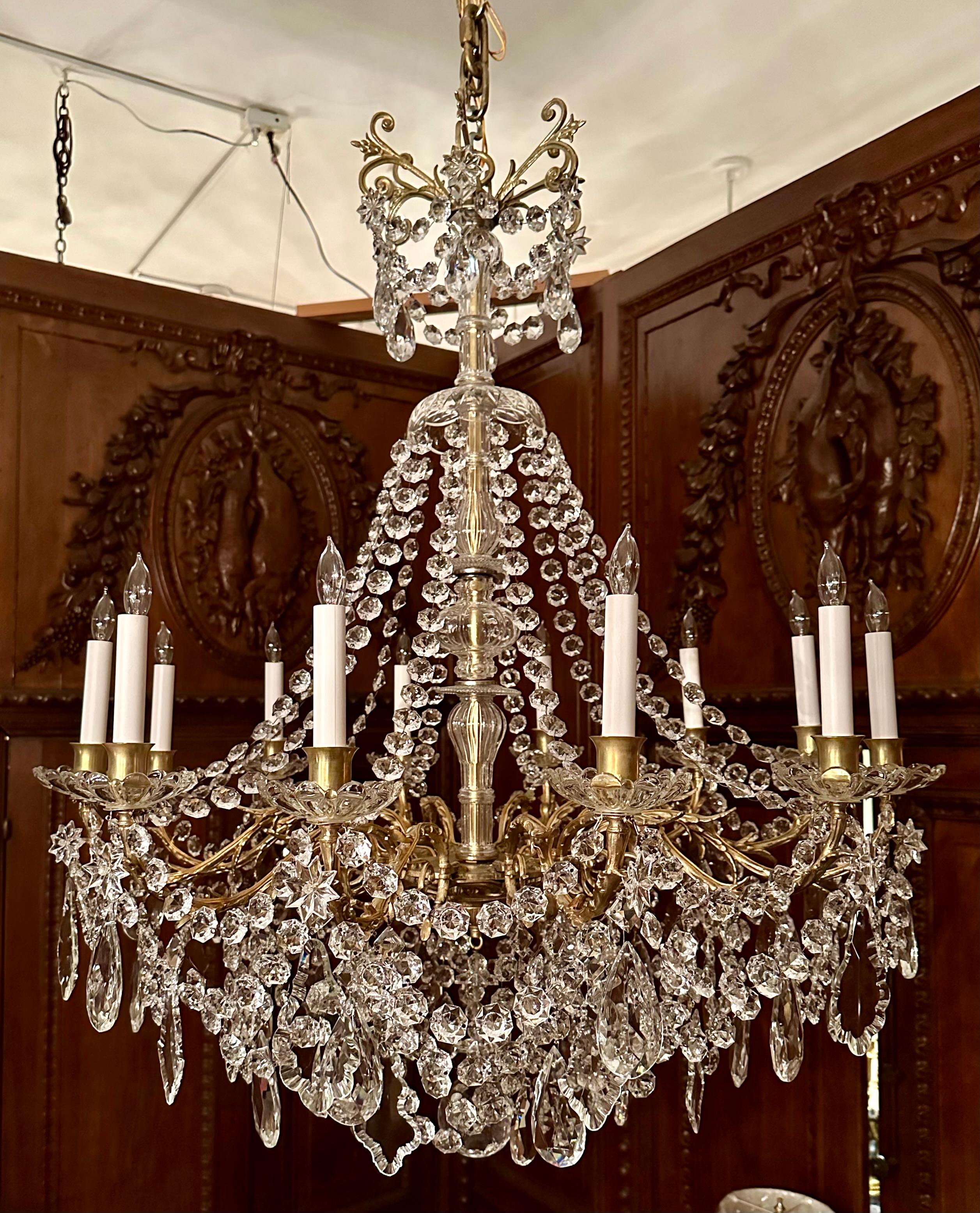 Antique French Gold Bronze and Baccarat Crystal 12 Light Chandelier, Circa 1890.
Heavily Draped with Cut Crystal Beading and Prisms.