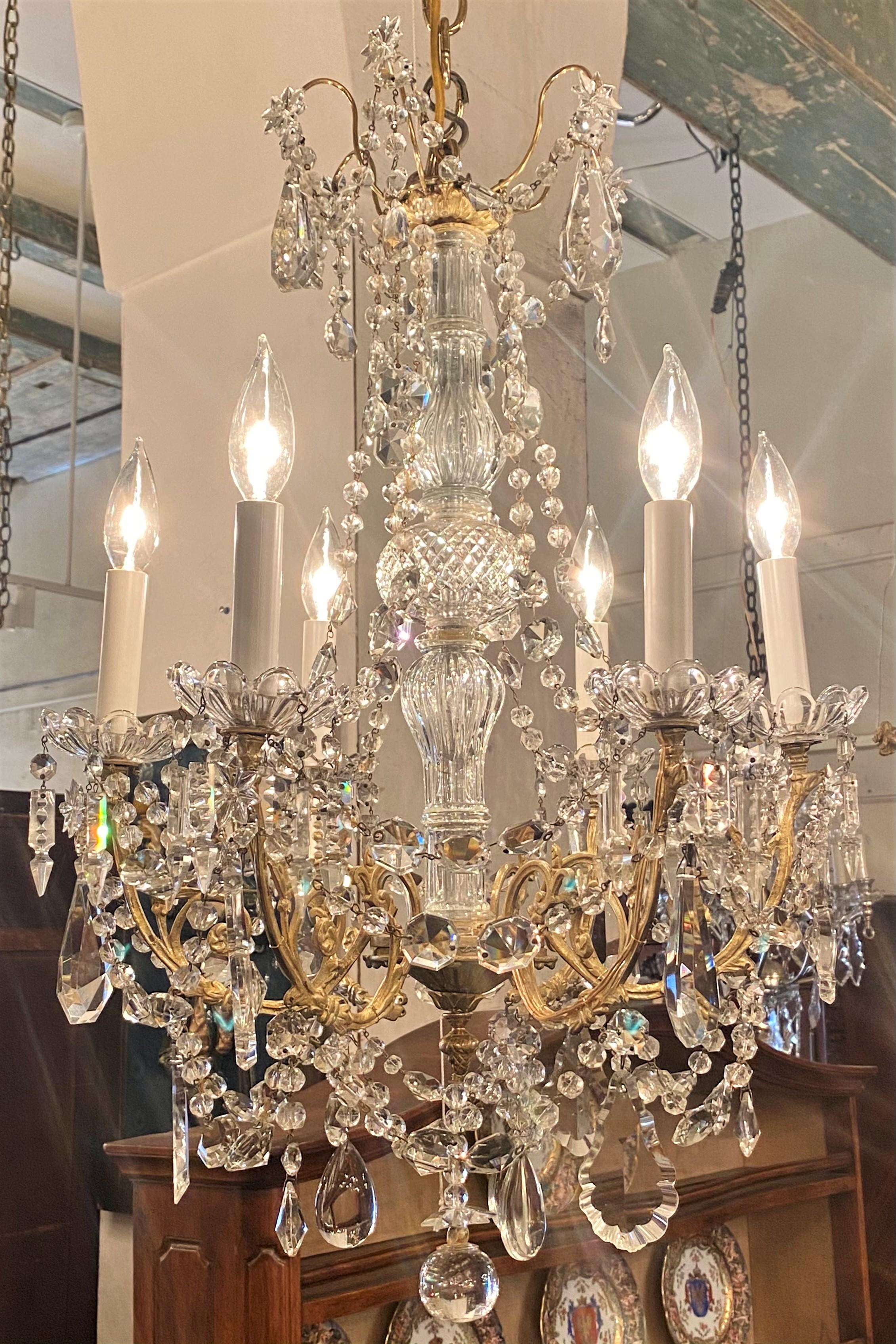 Antique French gold bronze and cut crystal 6 - light chandelier, circa 1890.
Beautiful crystal stem with lovely draped beading and cut crystals.
Shipped with matching canopy and 3ft of chain (more chain available if needed).