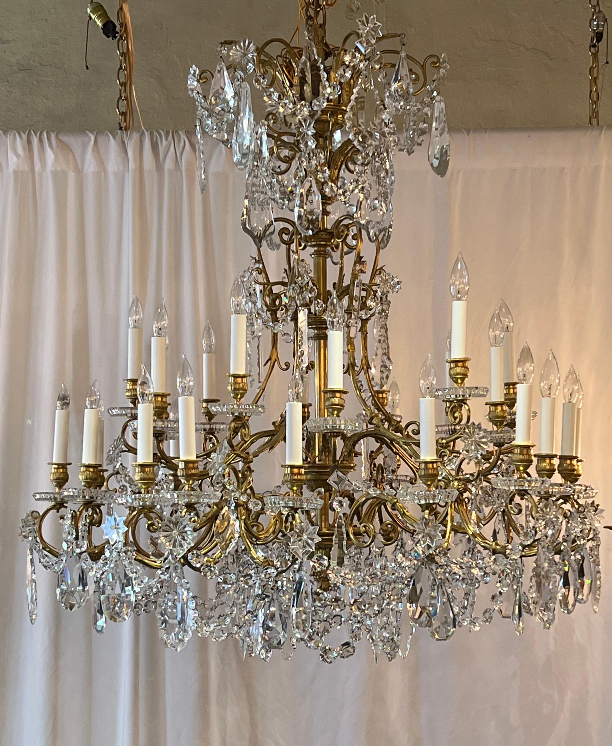 Magnificent Antique French Gold Bronze and Baccarat Cut Crystal 30 Light Chandelier, Circa 1900-1920.
Substantial draping of baccarat prisms and beads.