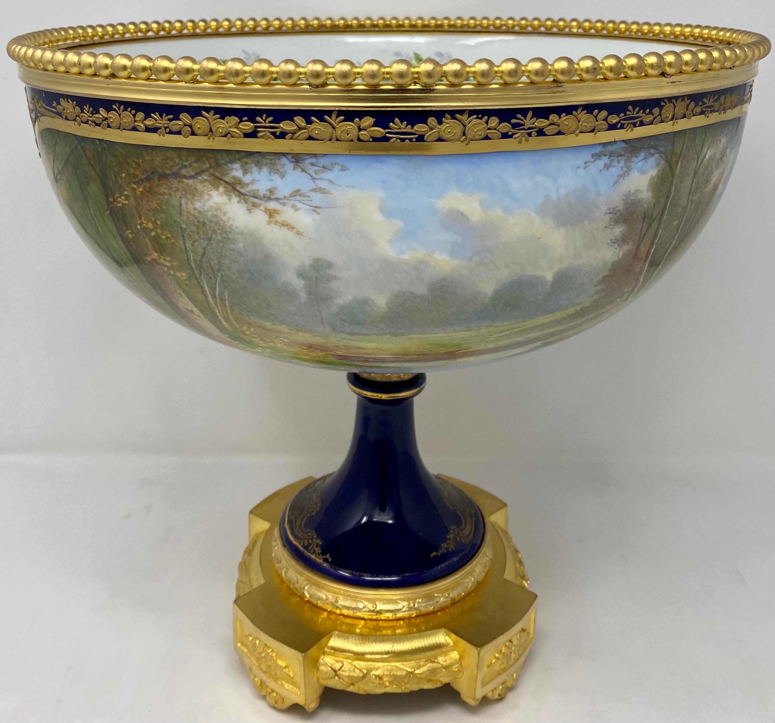 Antique French gold bronze mounted cobalt blue Sevres porcelain centerpiece, Circa 1890.
This centerpiece has different images on each side as shown in the pictures.
 