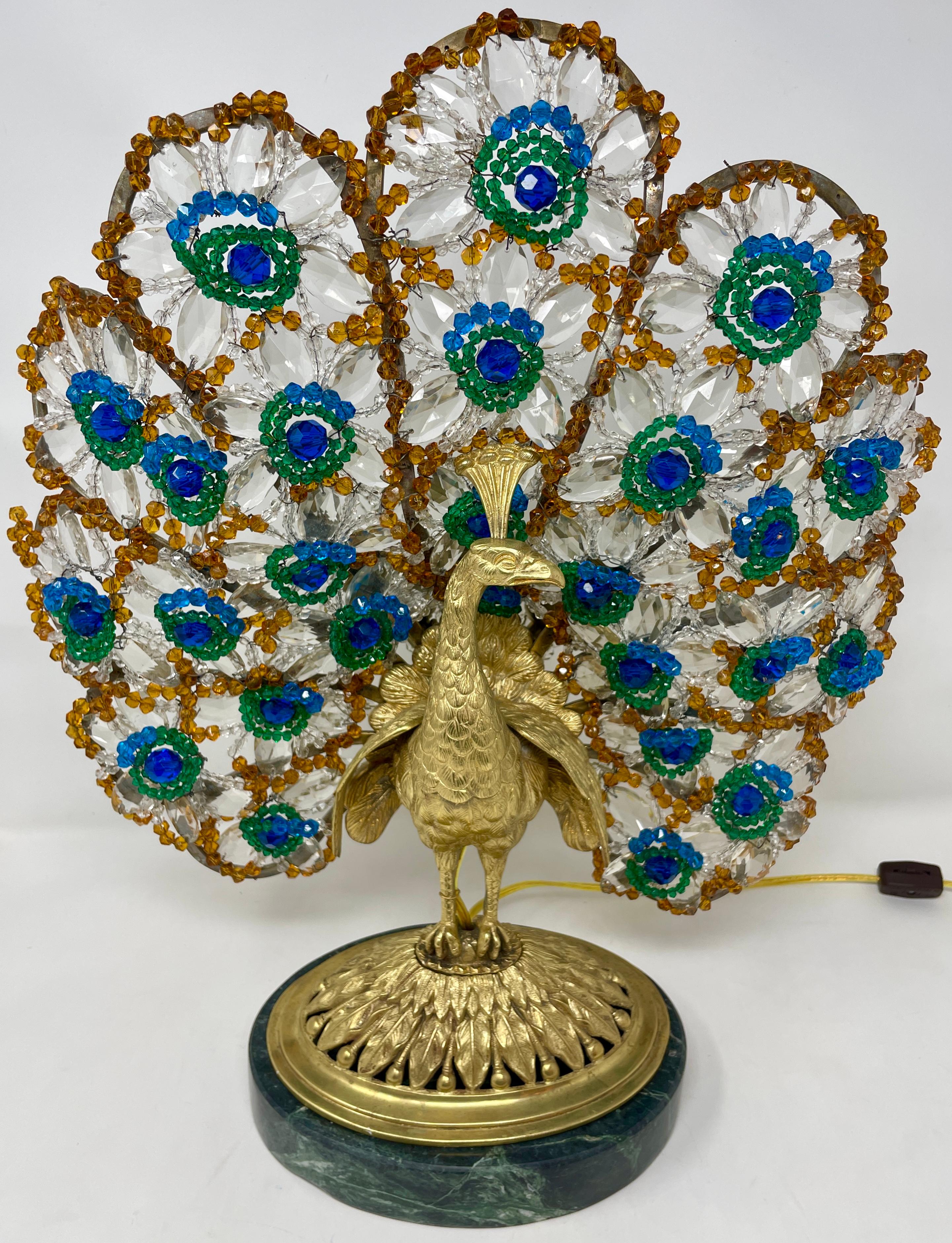 Antique French Art Deco gold bronze and multi-colored crystal peacock lamp on green marble base, circa 1900-1920.