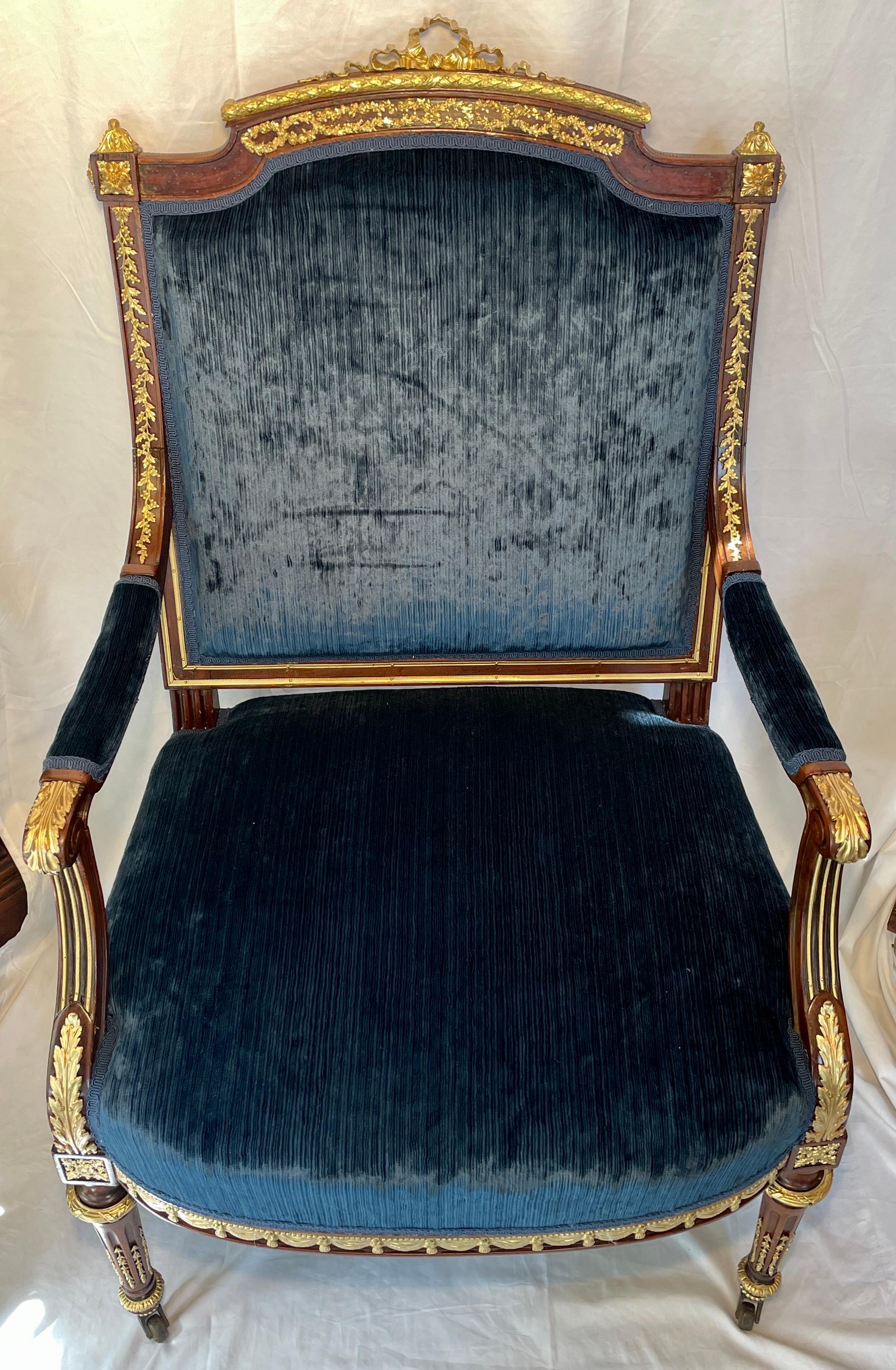 Antique French gold bronze mounted mahogany armchair with delicate trim, circa 1875-1885.