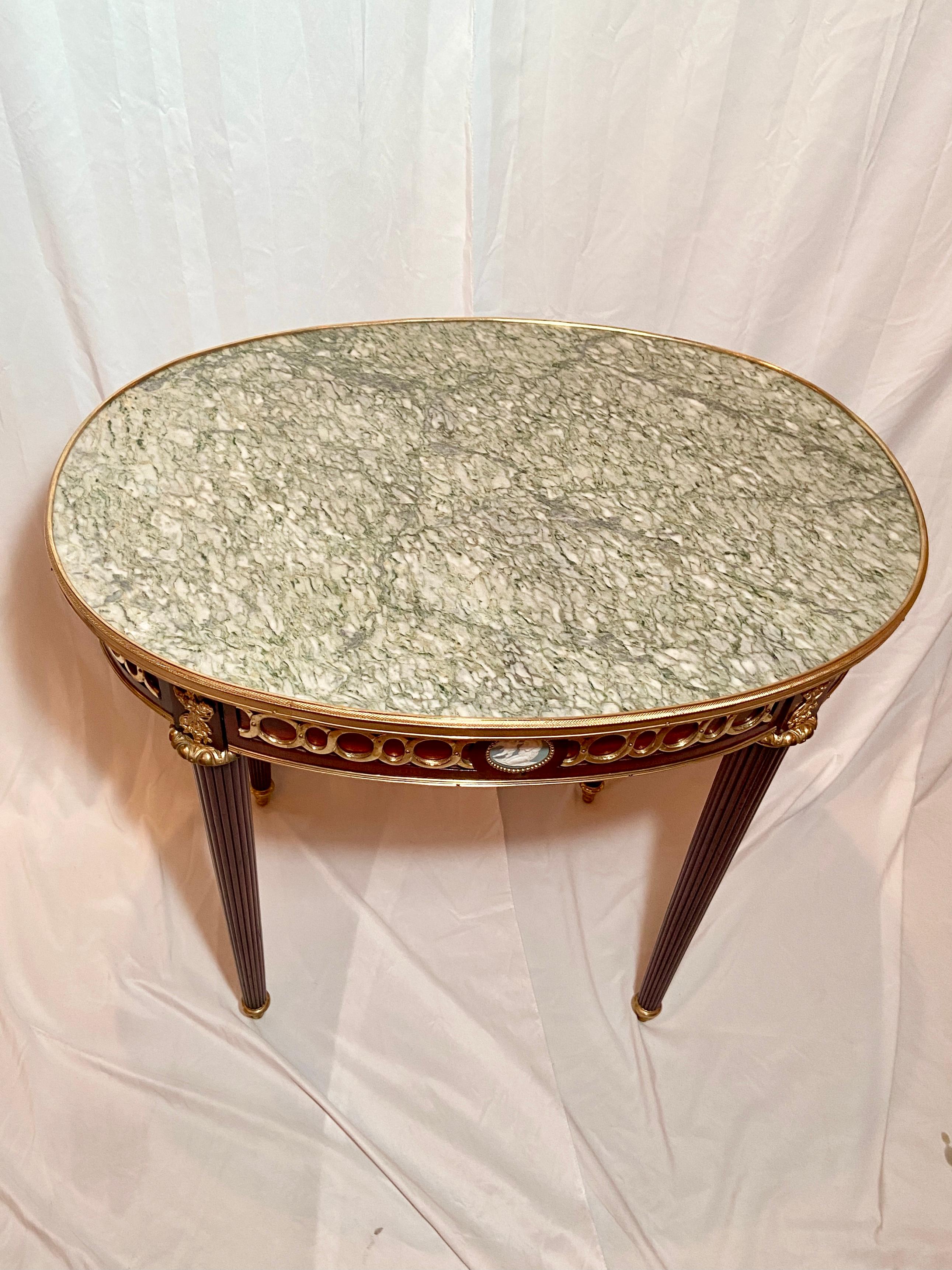 Antique French gold bronze mounted mahogany occasional table with marble top and wedgwood plaque, Circa 1880.