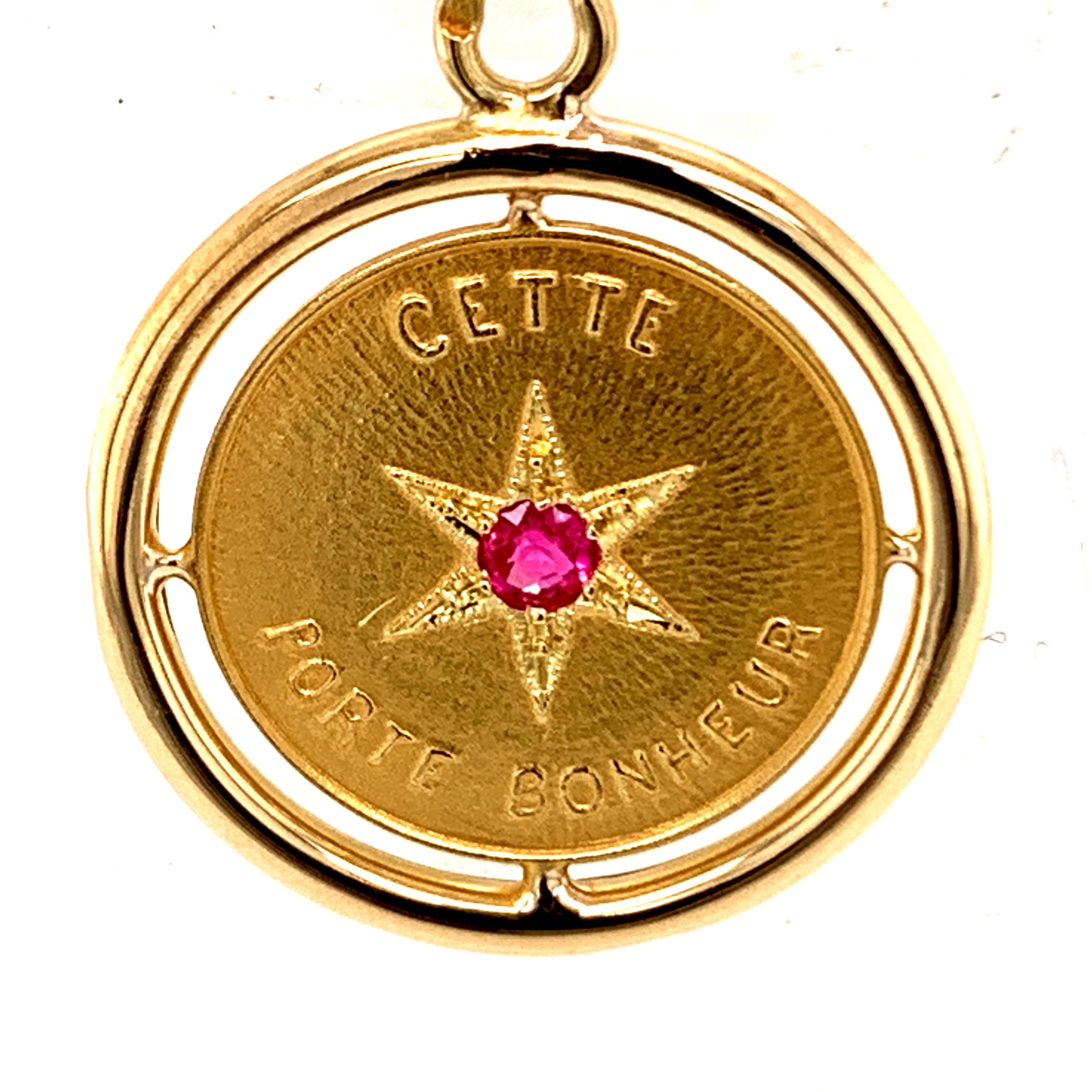 Charming French charm:  with an openwork 18K shiny gold bezel border and a satin gold center.  Applied letters spell out:  