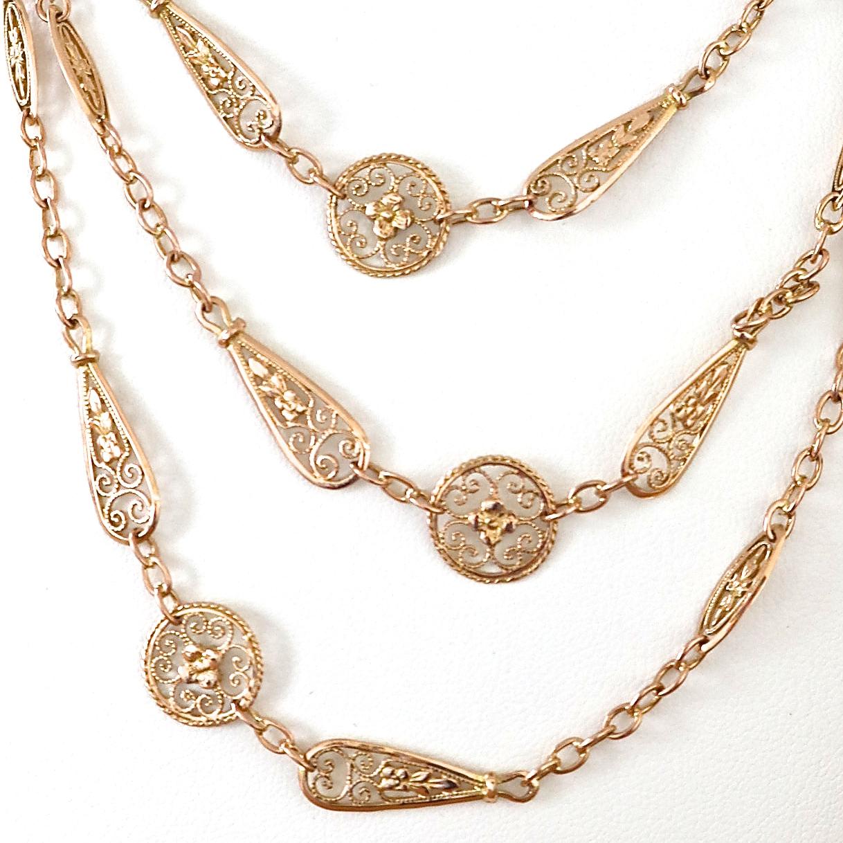 Luxurious Antique French 18k gold necklace with unique chain links and ornamental round and tapered stations. The length is 46 inches and is great for layering or as a stand alone adornment. 