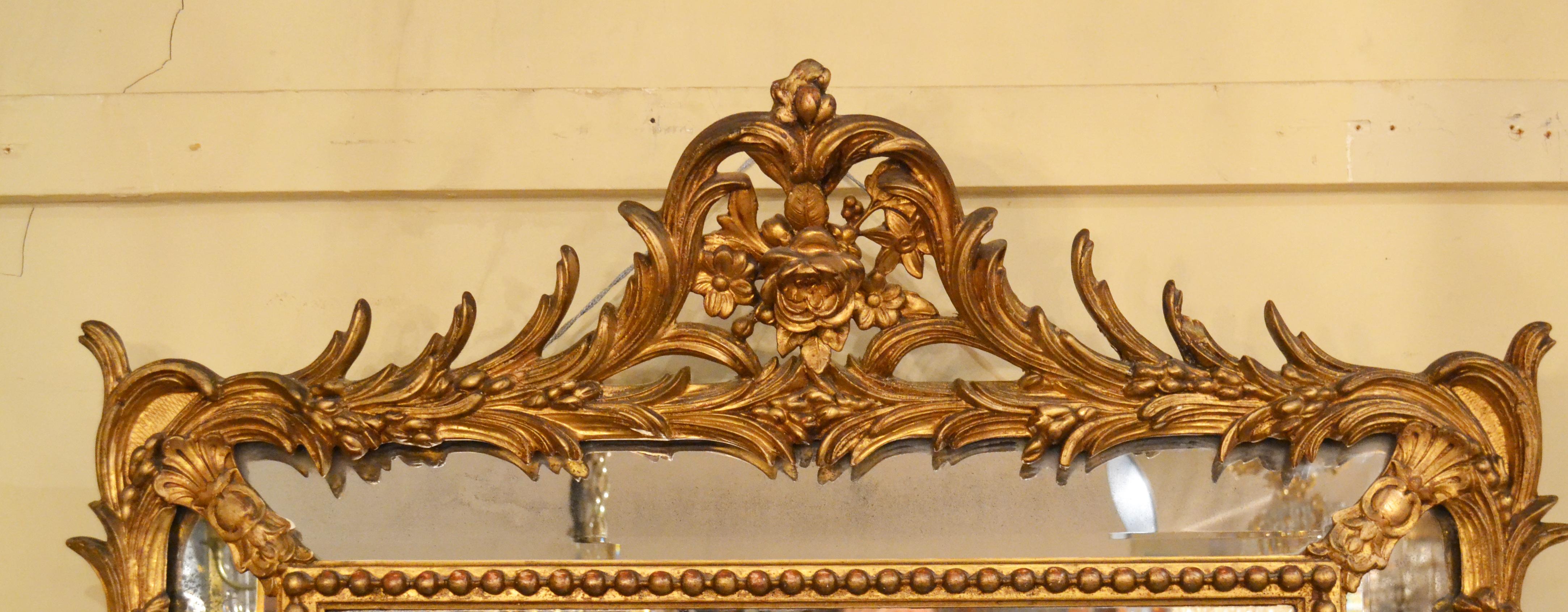 Antique French gold leaf beveled mirror. Nicely rendered with handsome decoration.