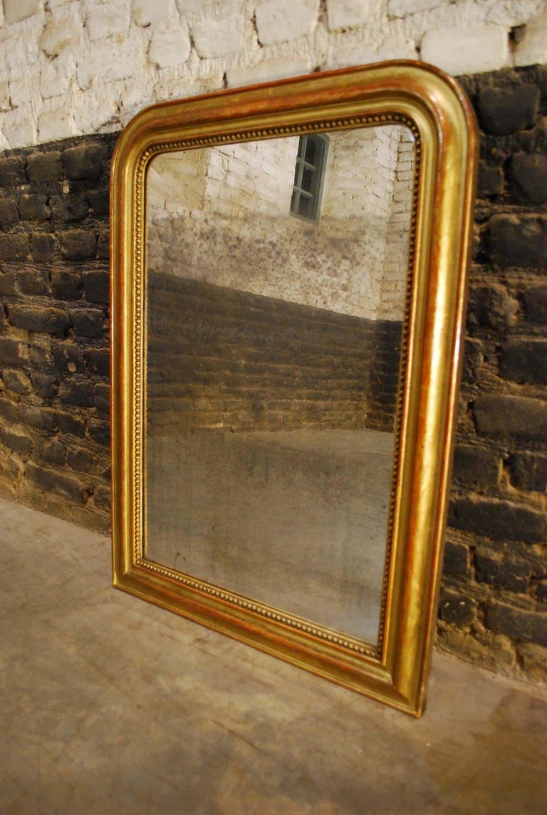 A beautiful small Louis Philippe mirror made in Southern France, circa 1870.
It has the upper rounded corners that are typical for a Louis Philippe mirror. The mirror frame is made in solid pine, smoothened with gesso.
The most elevated part