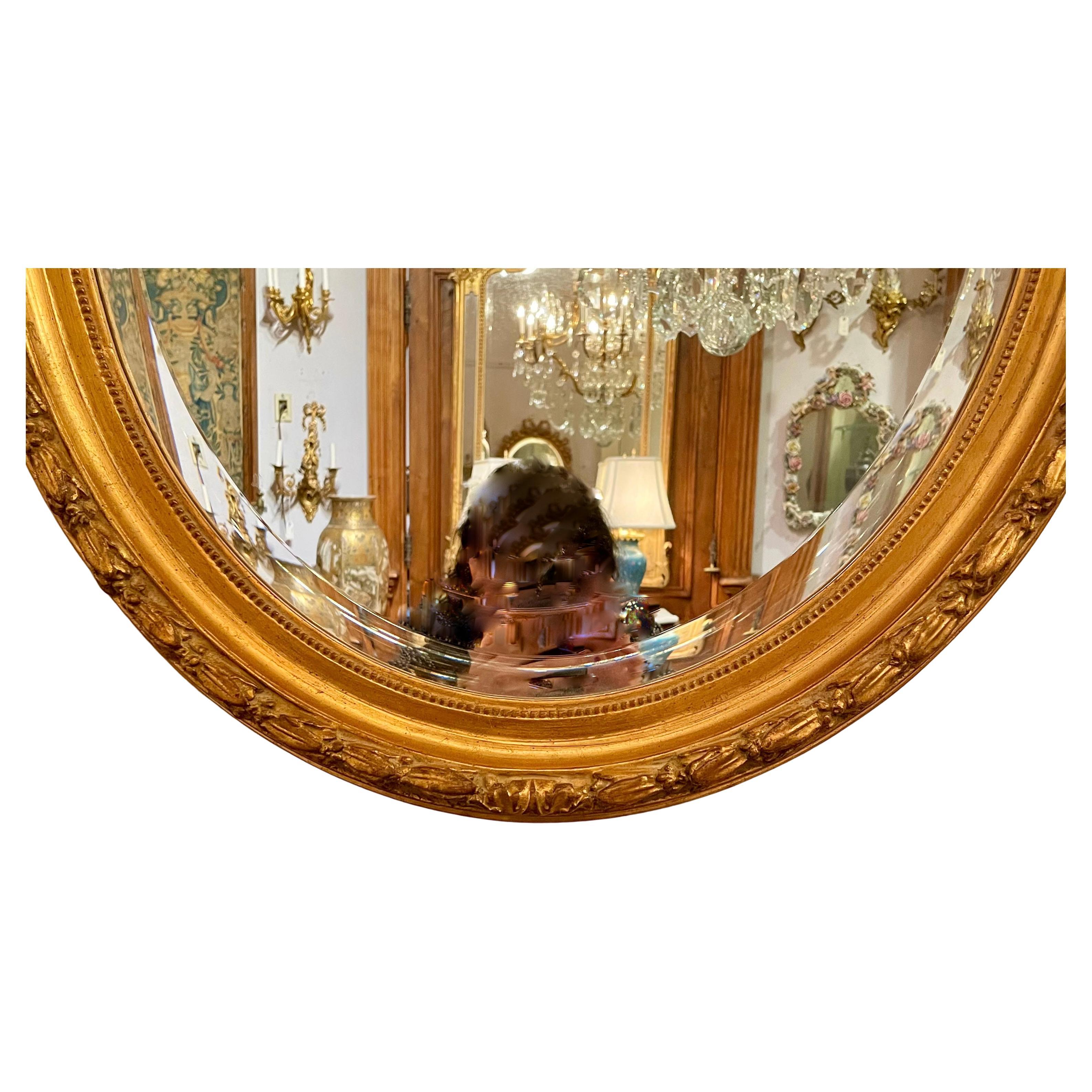Miroir ovale ancien en or avec biseau et ruban sculpté, Circa 1890.