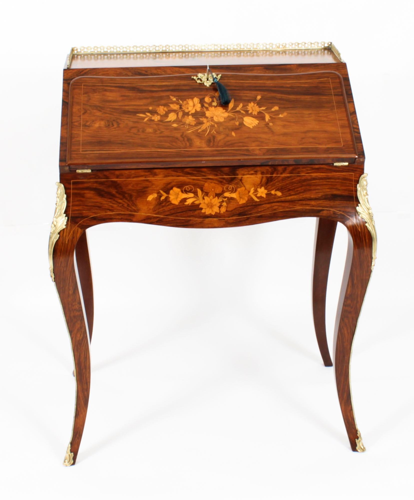 This is an elegant antique French Louis Revival ormolu mounted Gonçalo Alves bureau de dame, dating from circa 1860.
The fall front features floral marquetry decoration and opens to reveal a fitted interior with a six pigeon holes, three small