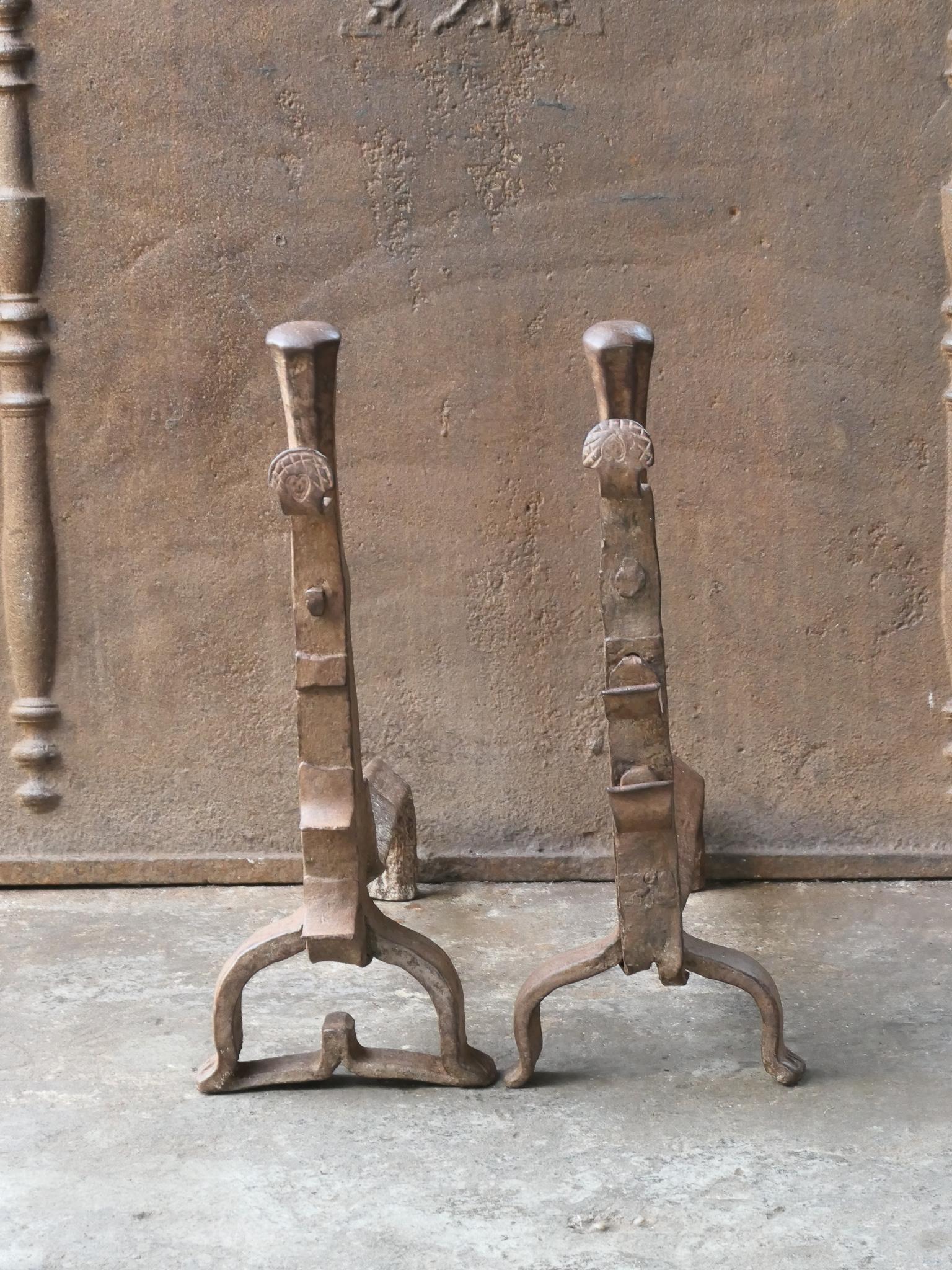 17th century French andirons made of wrought iron. The style of the andirons is gothic. Some ornaments are missing, but they are in a good functional condition.