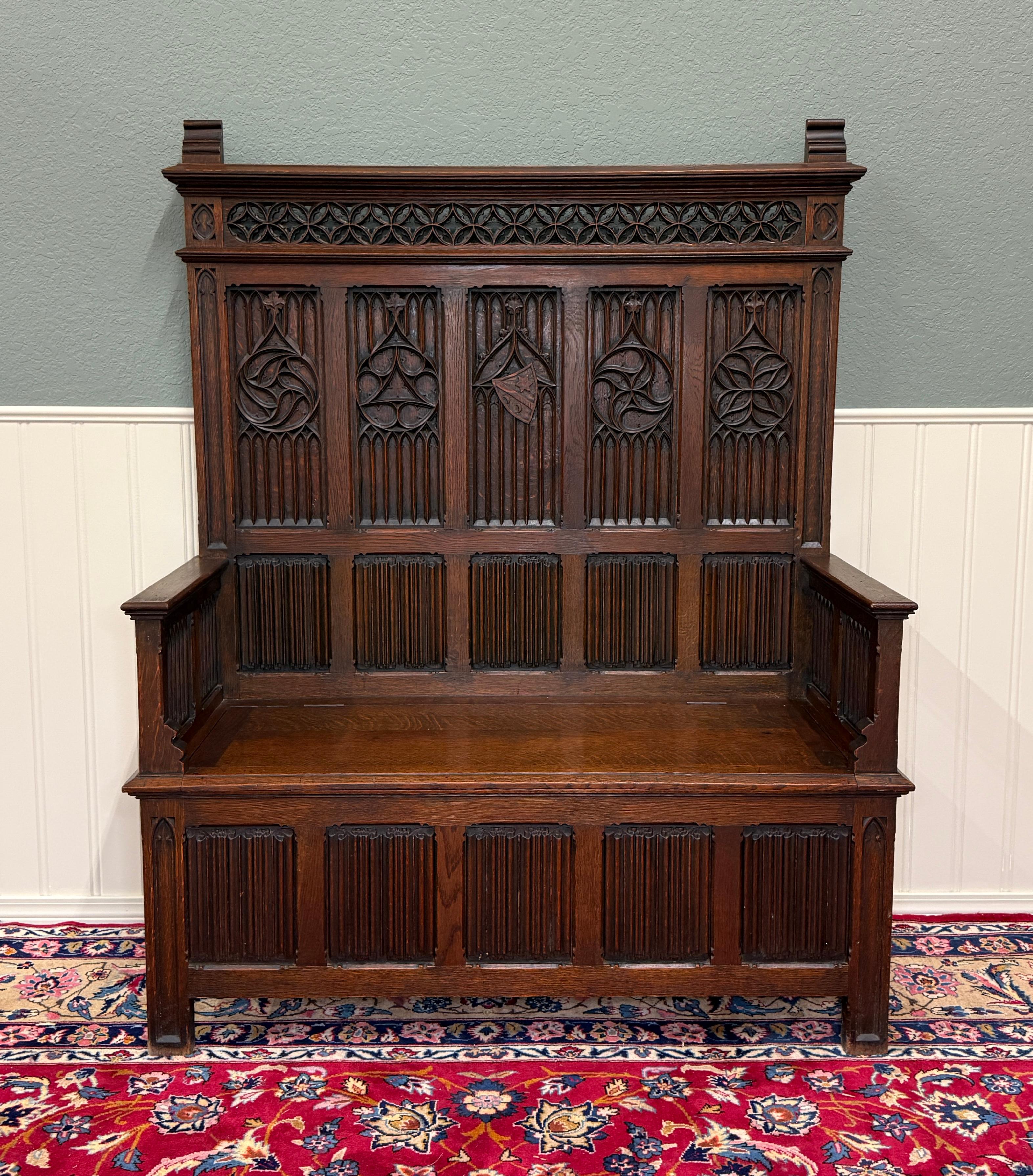 BEAUTIFUL Antique French Oak GOTHIC REVIVAL Bench, Settee or Church Pew with Lift-Top Seat for Storage~~HIGHLY CARVED ~~c. 
1900


        Spectacular design elements featuring linen fold and shield carvings with paneled back

        Hinged