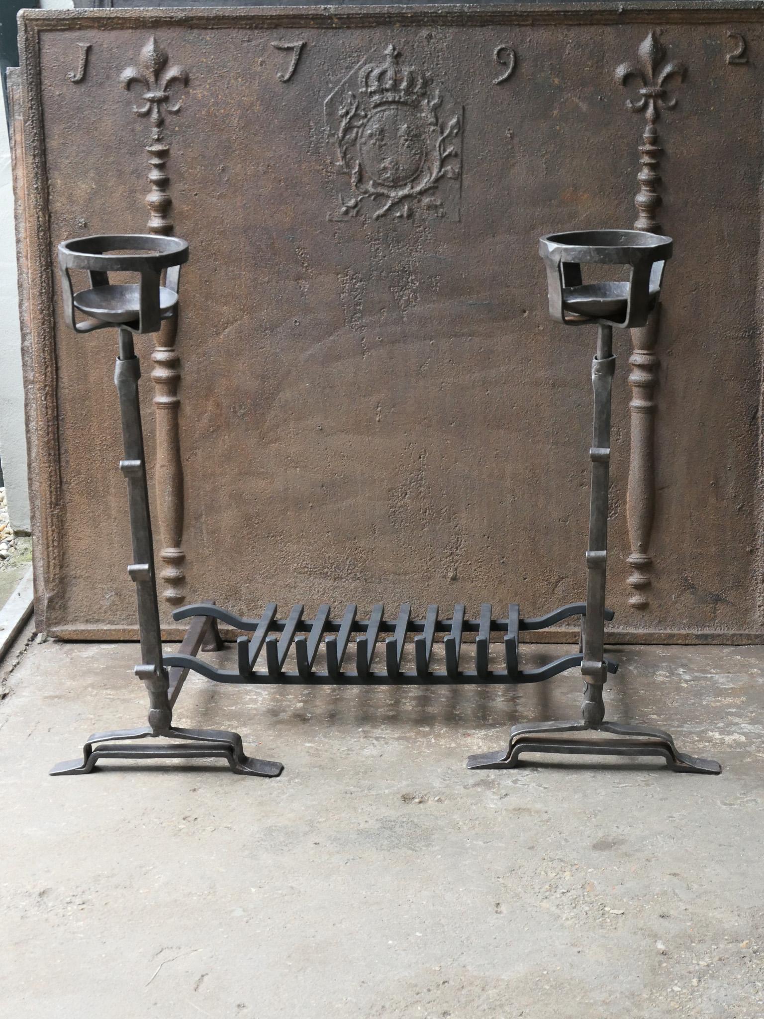 17th - 18th century French Gothic fire grate with period andirons and a recently forged grate. Made of wrought iron. The condition is good. 

The total width at the front of the grate is 88 cm / 34.6 inches.







