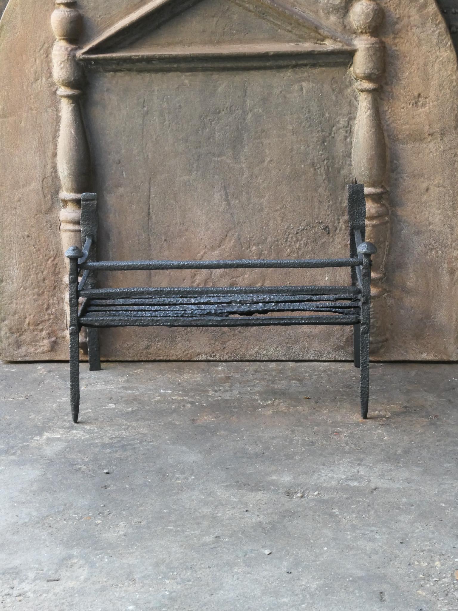Late 17th or early 18th century French Gothic period fire grate. Hand forged of wrought iron. The condition of the basket is good. 










