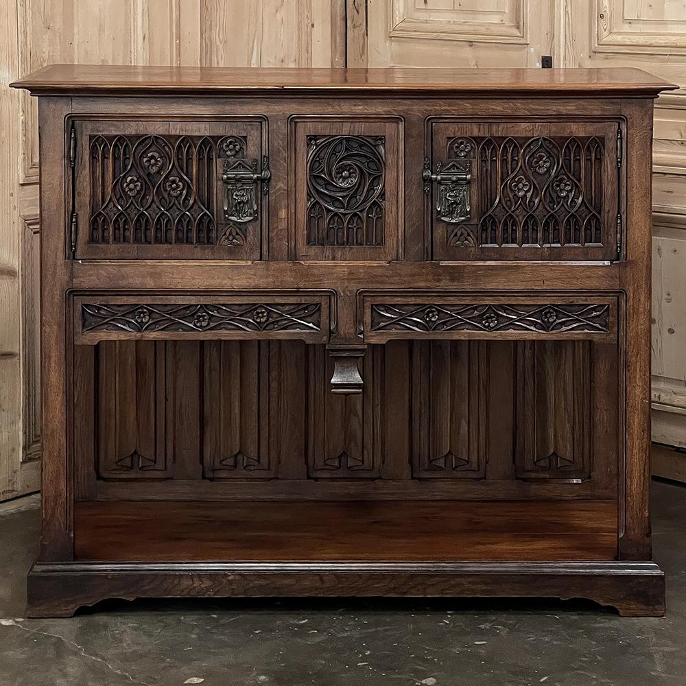 Antique French Gothic Raised Cabinet is a magnificent expression of the style that had its origins in mid-12th century France! Raised up on legs to provide ease of access, it features a very sturdy top perfect for display, with another full width