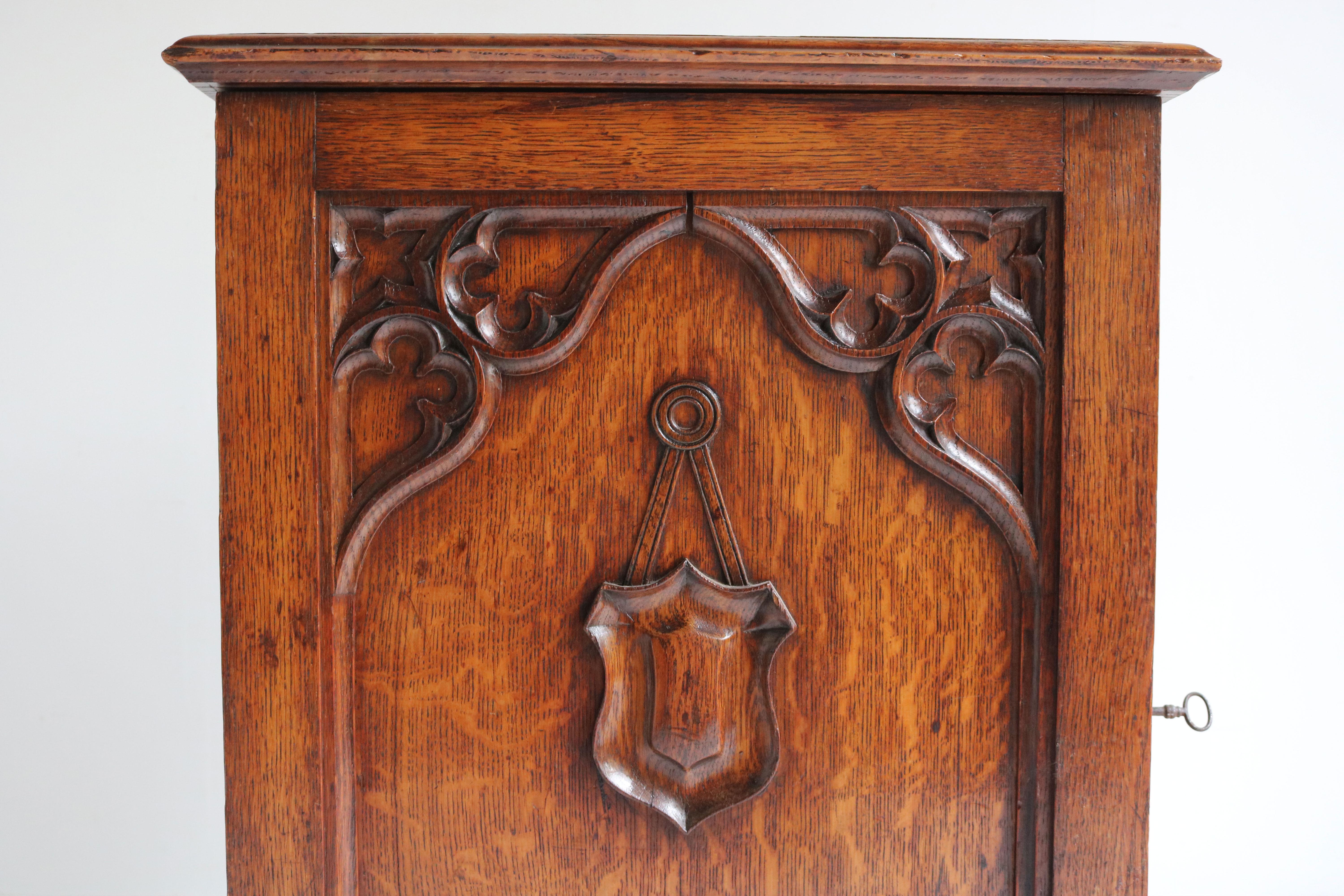 Exquisite Antique Gothic Revival French antique Small cabinet / Wall cabinet from a church made from solid Oak 19th century. 
The cabinet has a gorgeous decorated front door with Gothic symbols , amazing patina on the European oak. 
The interior