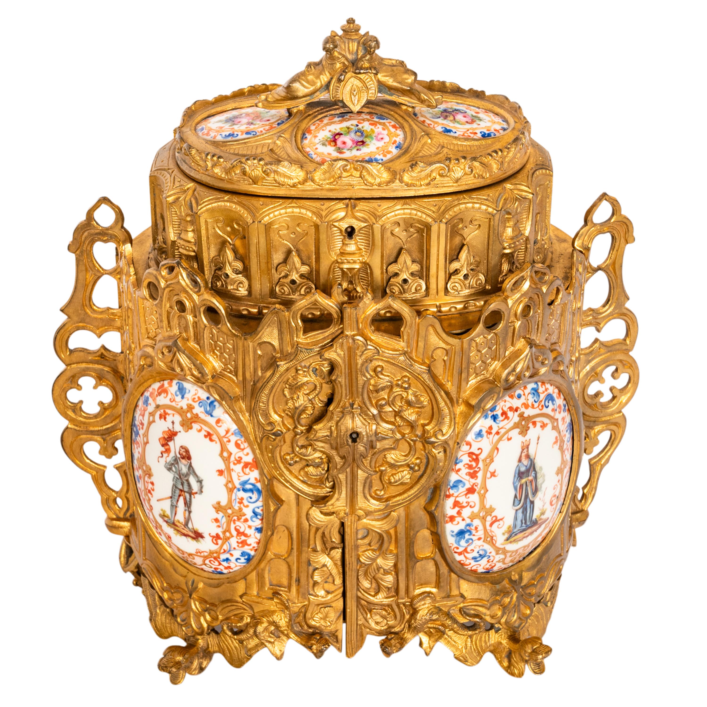 A fine antique French Gothic Revival/Medieval gilt bronze jewelry casket, with prorcelain panels, circa 1870.
An identical jewelry casket sold on 1stdibs reference number LU155624346173, listed price $6,500.
The jewelry box is modeled on a