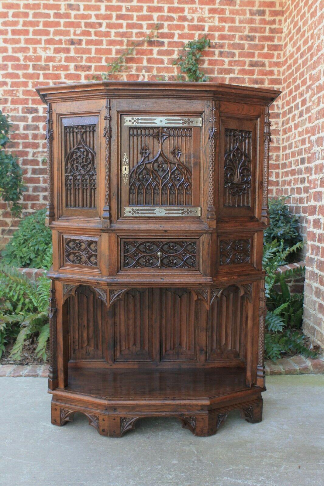 Exceptionally carved antique French oak Gothic sacristy vestry altar wine cabinet~~c. 1870s-1880s 

In 18th and 19th century Europe, sacristy or vestment cabinets were used to store liturgical garments, robes, wine and other articles associated