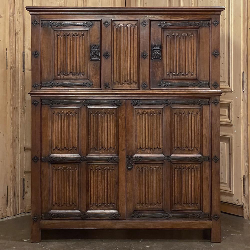 Antique French Gothic wardrobe ~ cabinet is an intriguing example of the style, with no less than 23 hand-carved linenfold panels combining with long, forged strap hinges, rosettes and lockworks to create a timeless Old World look! Hand-crafted from
