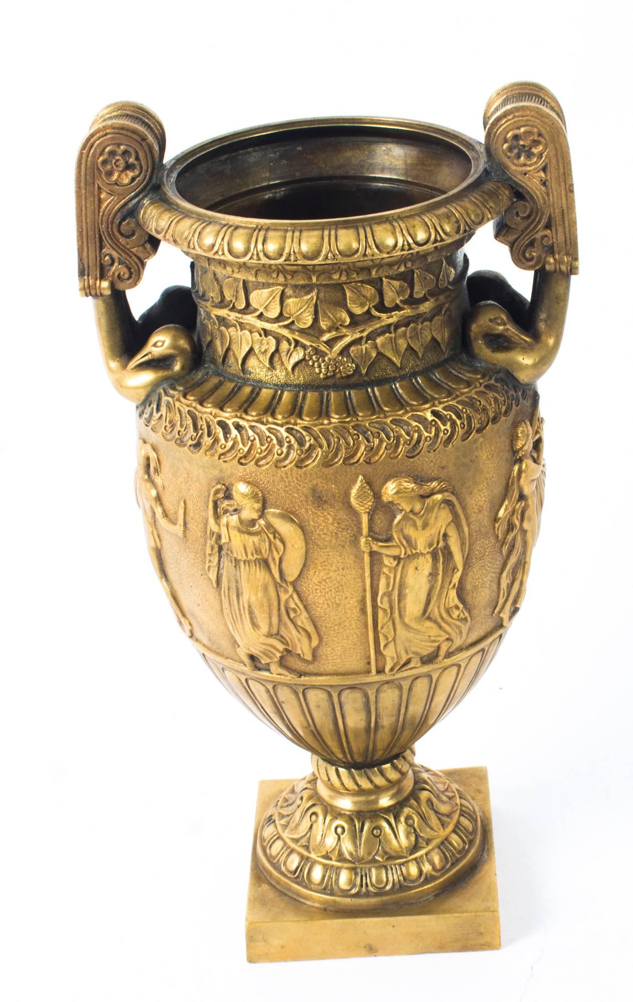 This is a fine antique French Grand Tour gilt bronze Athenian Volute Krater vase, circa 1820 in date.

The elegant vase's body is sculpted with finely detailed low relief decoration consisting of a bacchanalian scene. The neck features a