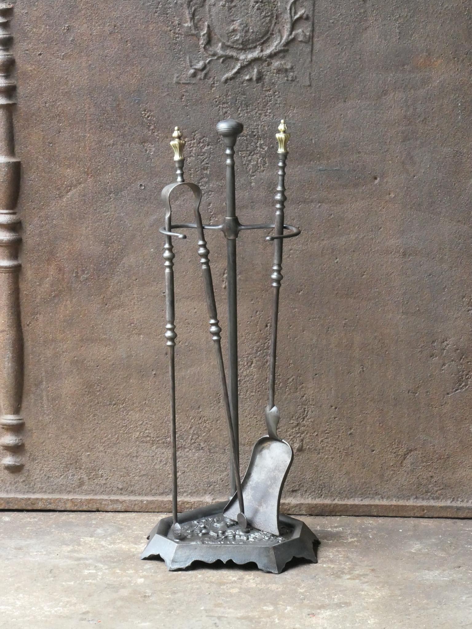 19th-century French Napoleon III period fireplace set. The tool set consists of thongs, a shovel and a stand. It is made of wrought iron and cast iron with brass details. The set is signed by 'Grandy Fils'. The condition is good.







