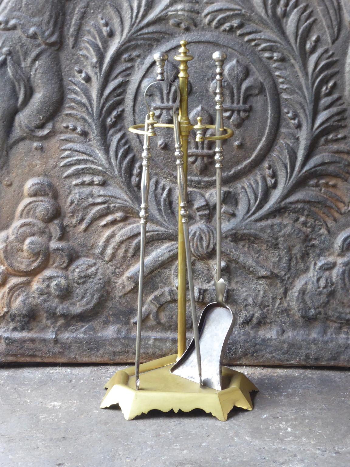 19th-century French Napoleon III fireplace tool set made of brass and wrought iron. The set is signed by 'Grandy Fils'. The tool set consists of a stand and two fireplace tools. The condition is good.







