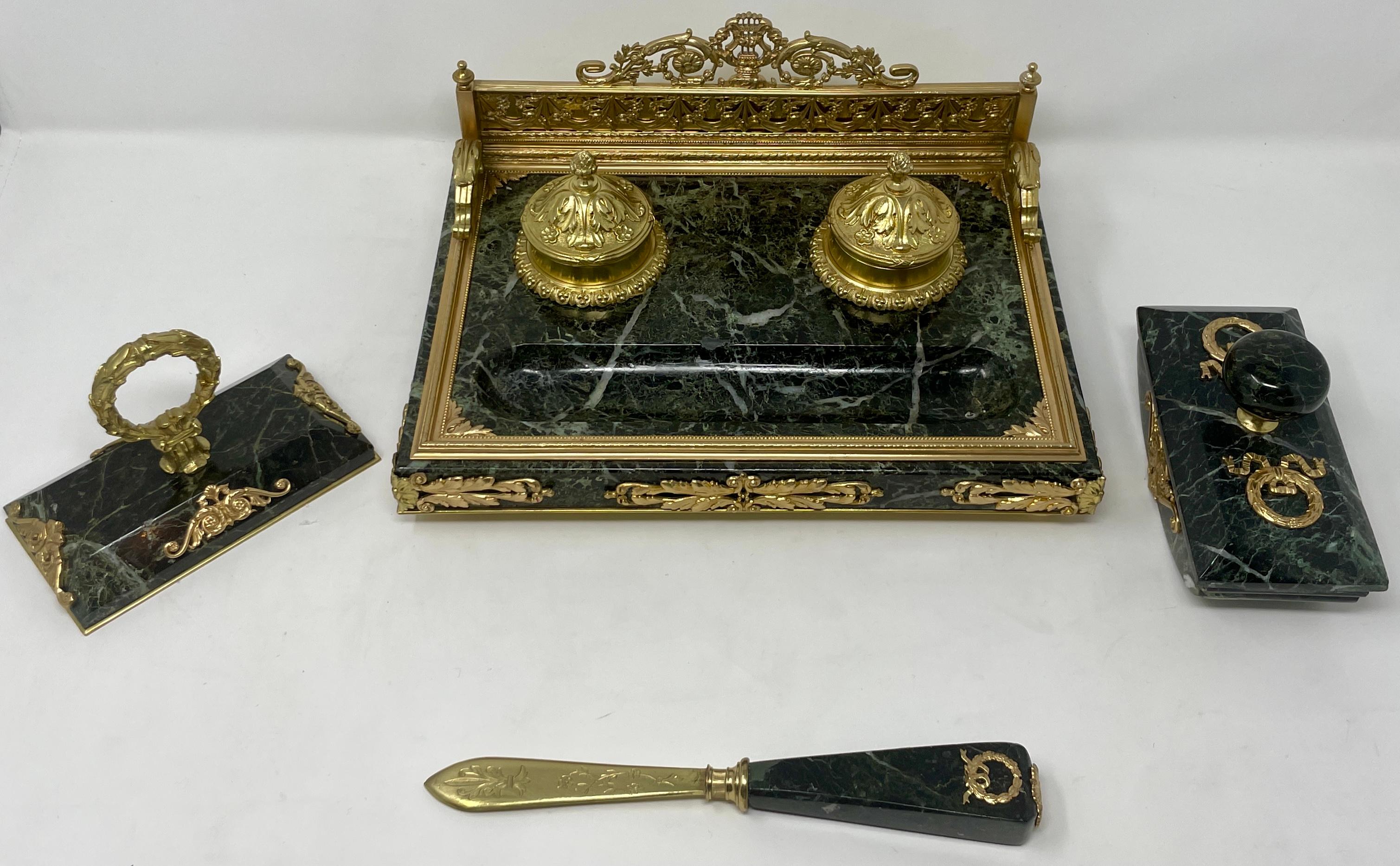 Exceptional Antique French green marble and gold bronze 4 piece inkwell desk set, circa 1875-1885.
Includes:
Inkwell: 11W x 8L x 4.75H
Paperweight (Left): 3W x 5.25L x 3.5H
Rolling Stamp (Right): 2.75W x 5.75L x 3.25H
Letter Opener: 1.25W x