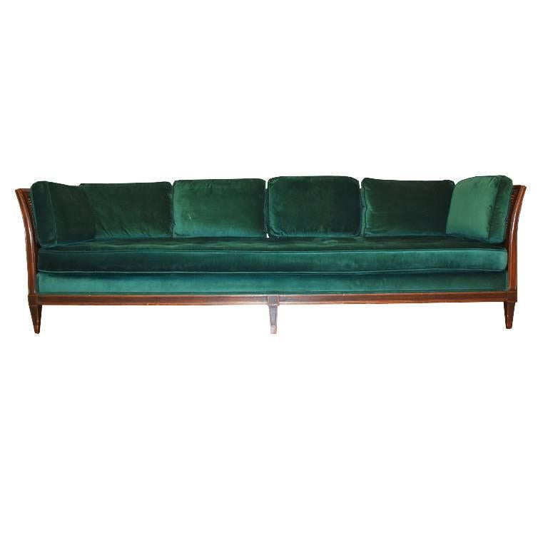 Beautiful green velvet sofa with square back and side pillows. Sides and back feature beautiful cane. Button tufted (or biscuit tufted) bottom cushion extends the entire width of the sofa. In great condition. Small chip on one of the back legs, but