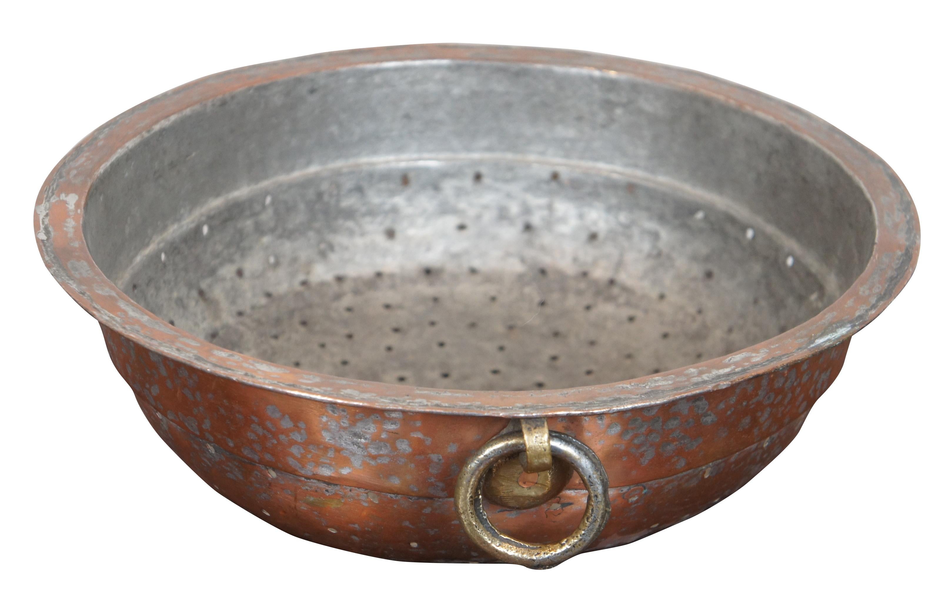 Antique French hand forged / hammered copper colander or strainer featuring dovetailing and a ring for hanging.
 