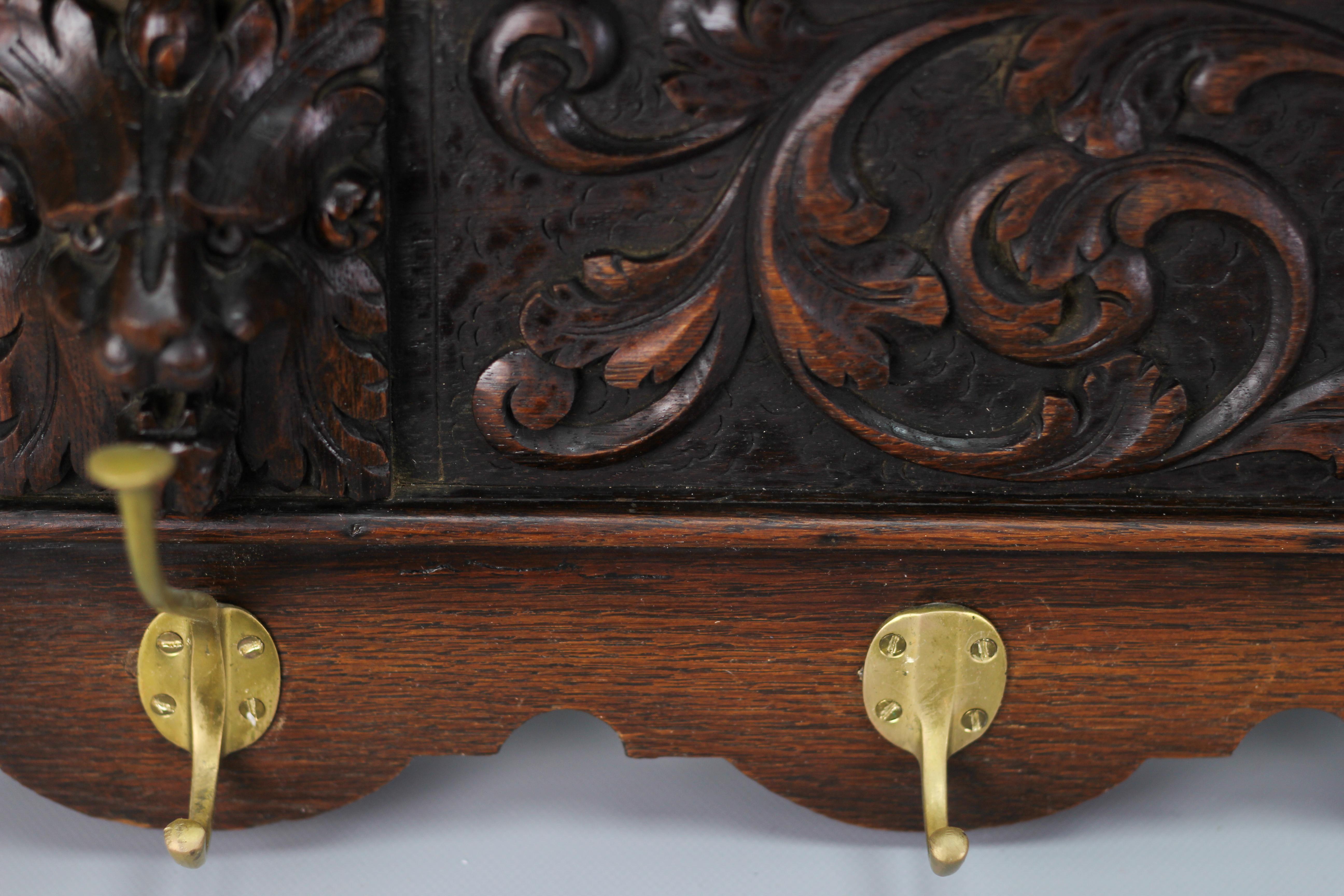 Renaissance Revival Antique French Hand-Carved Oak and Brass Wall Coat Rack with Lion Heads, 1900s For Sale