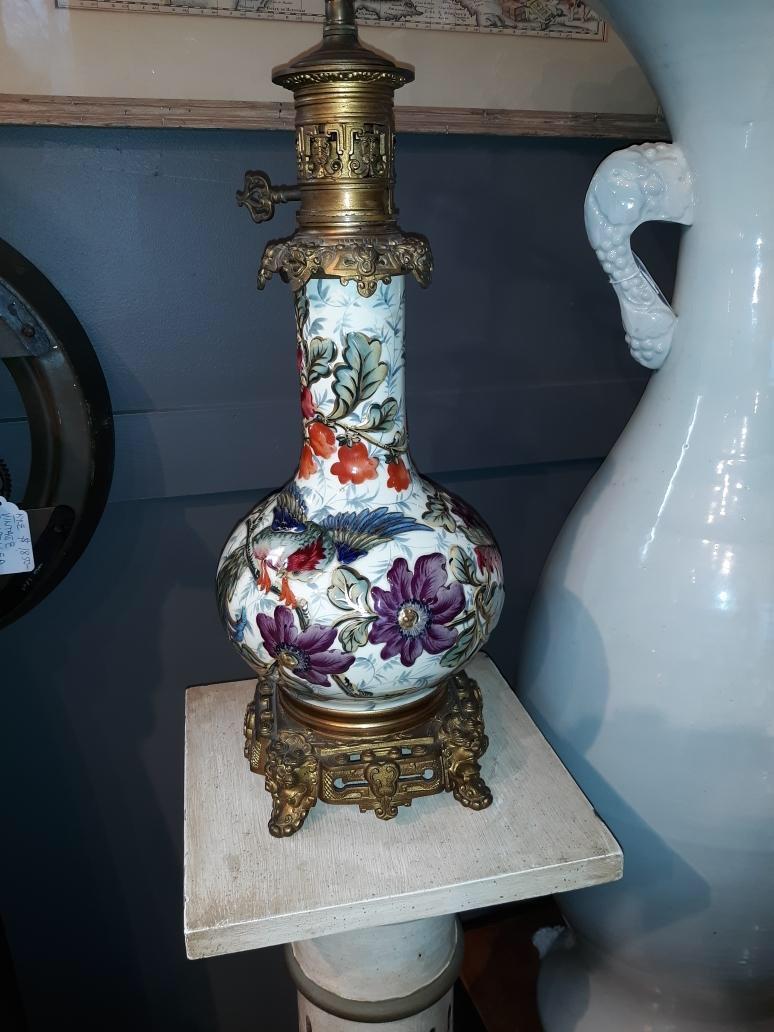 Vibrant French hand painted oil lamp now electrified. The floral bulbous body with gilt bronze mounts, circa 1870.