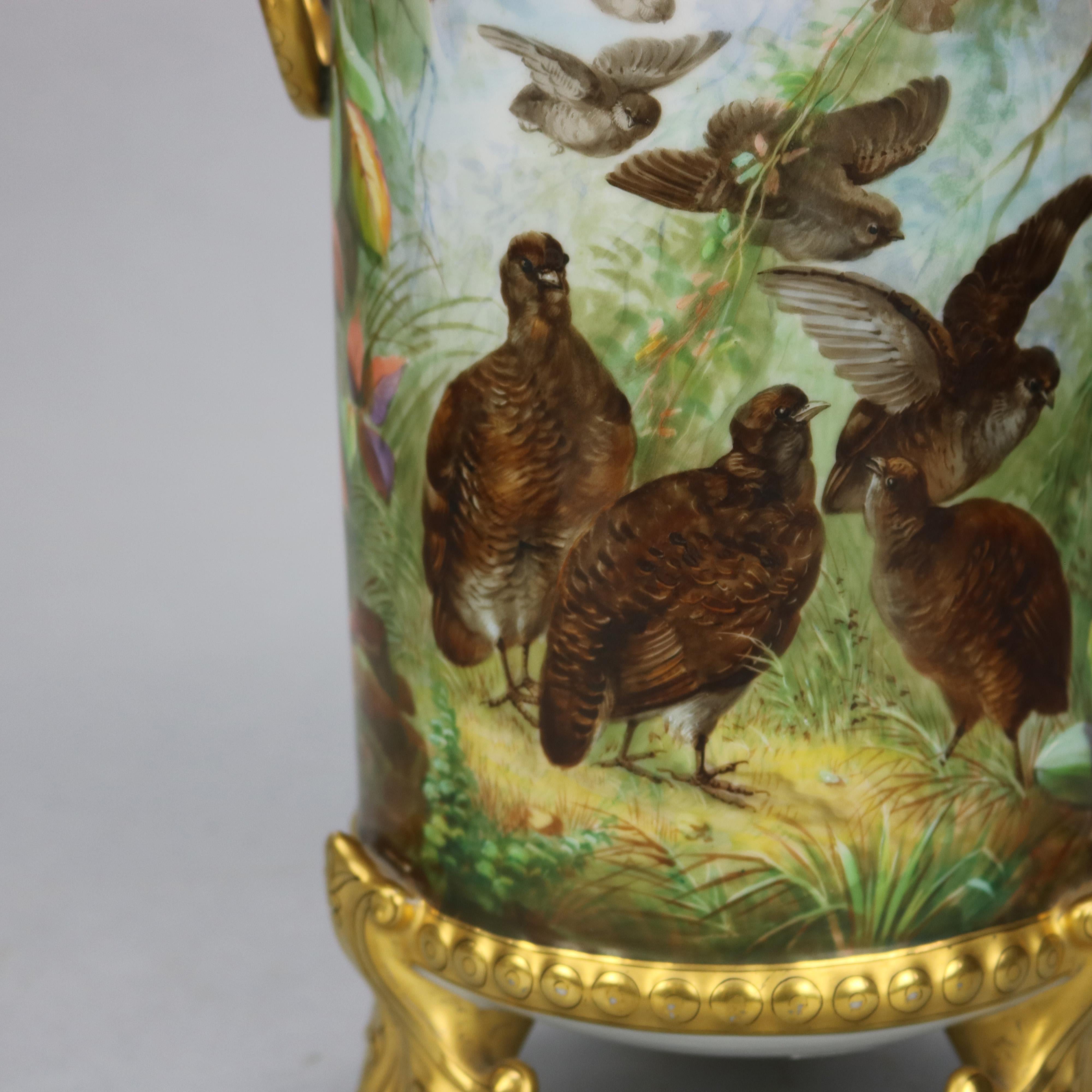 An antique French Haviland Limoges porcelain vase offers cylinder form with hand painted marsh or wetland scene having game birds including quail, upper pierced and gilt collar, double handles and foliate form feet, circa 1890

Measures: 14.5