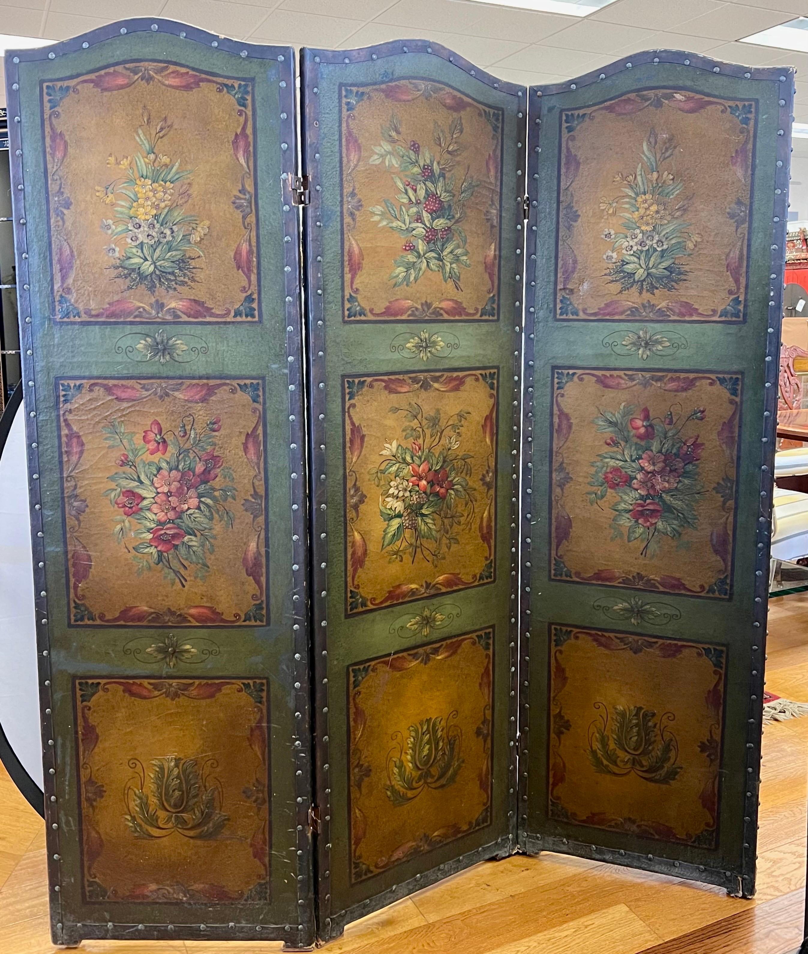 Antique 19th century French hand painted floral hinged three panel arched leather screen with brass tack trimming.  Each panel is 20