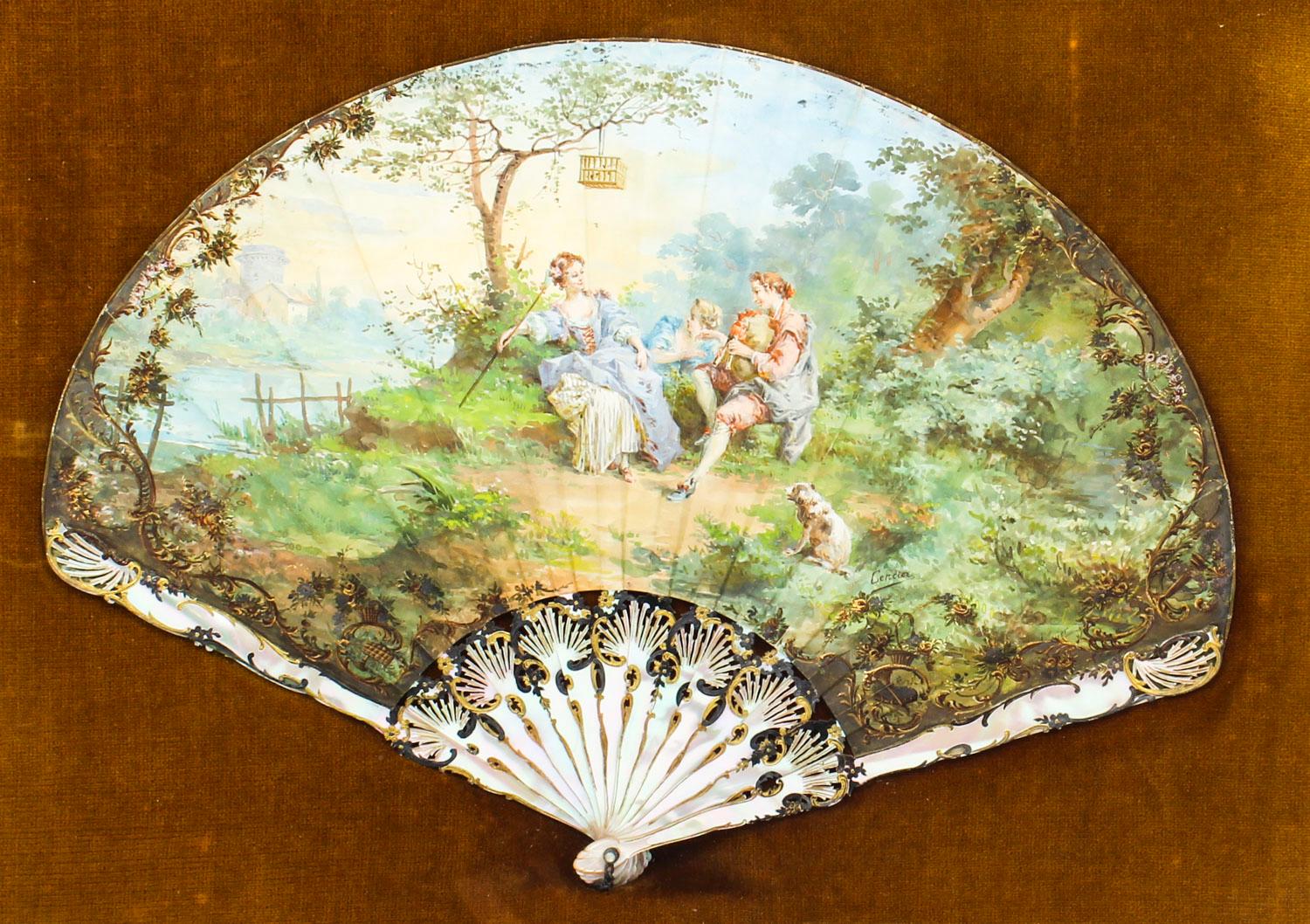 This is a beautiful decorative antique French mother of pearl fan, signed Cercier, set in a glazed giltwood frame dating from the late 18th century.

The fan is beautifully hand painted with figures at leisure against a landscape, on richly gilt