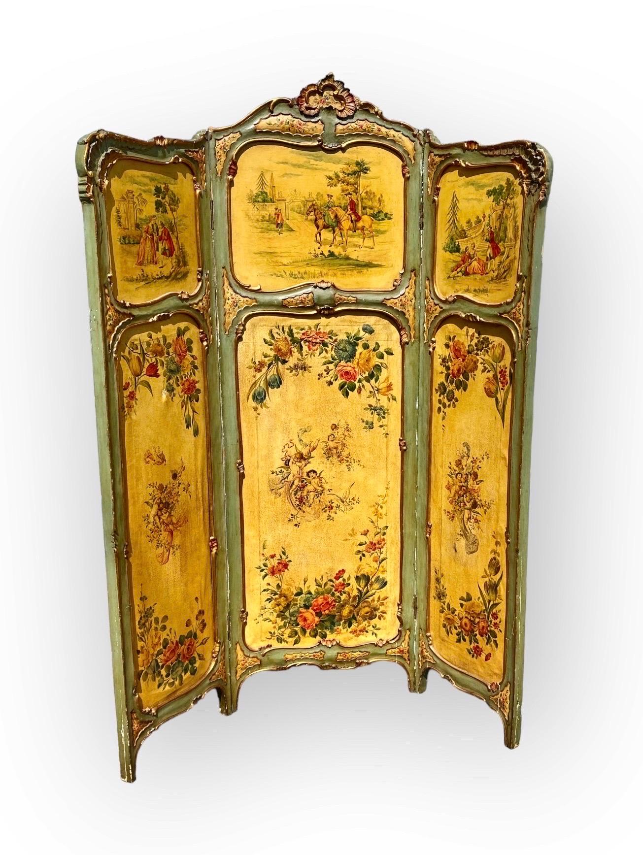 Antique French Louie XV style three panel folding dressing screen having decorative painted canvas panels depicting winged cherubs playing in green, red and ochre floral landscape scenes and 19th c. Figures in pastoral scenes, on grounds of lovely