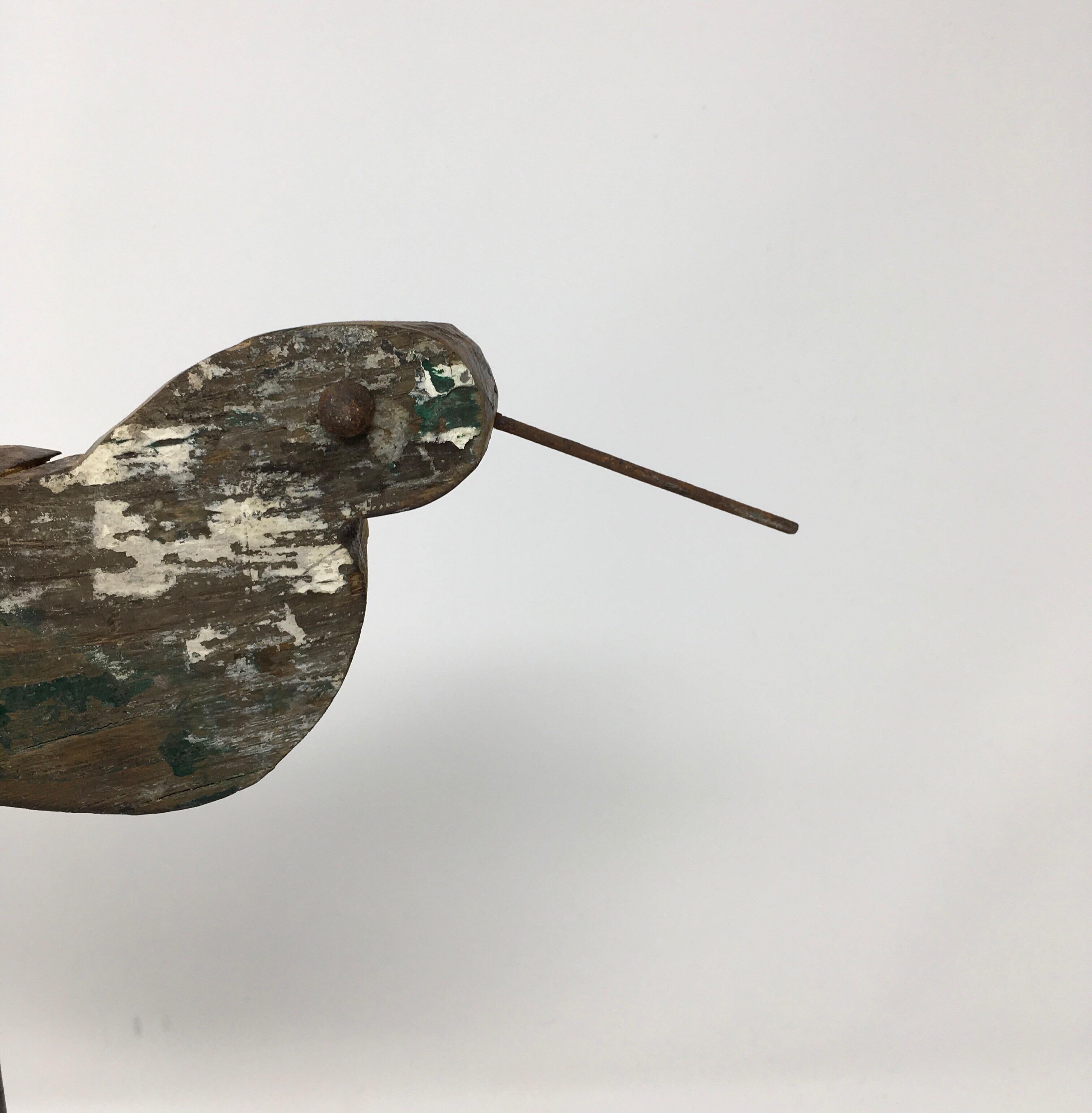 Found in the Provence Region of France, this antique handmade bird decoy is mounted on a new custom iron base. The eyes on this decoy are constructed with metal rivets. Today, these types of bird decoys add interest displayed on tables and