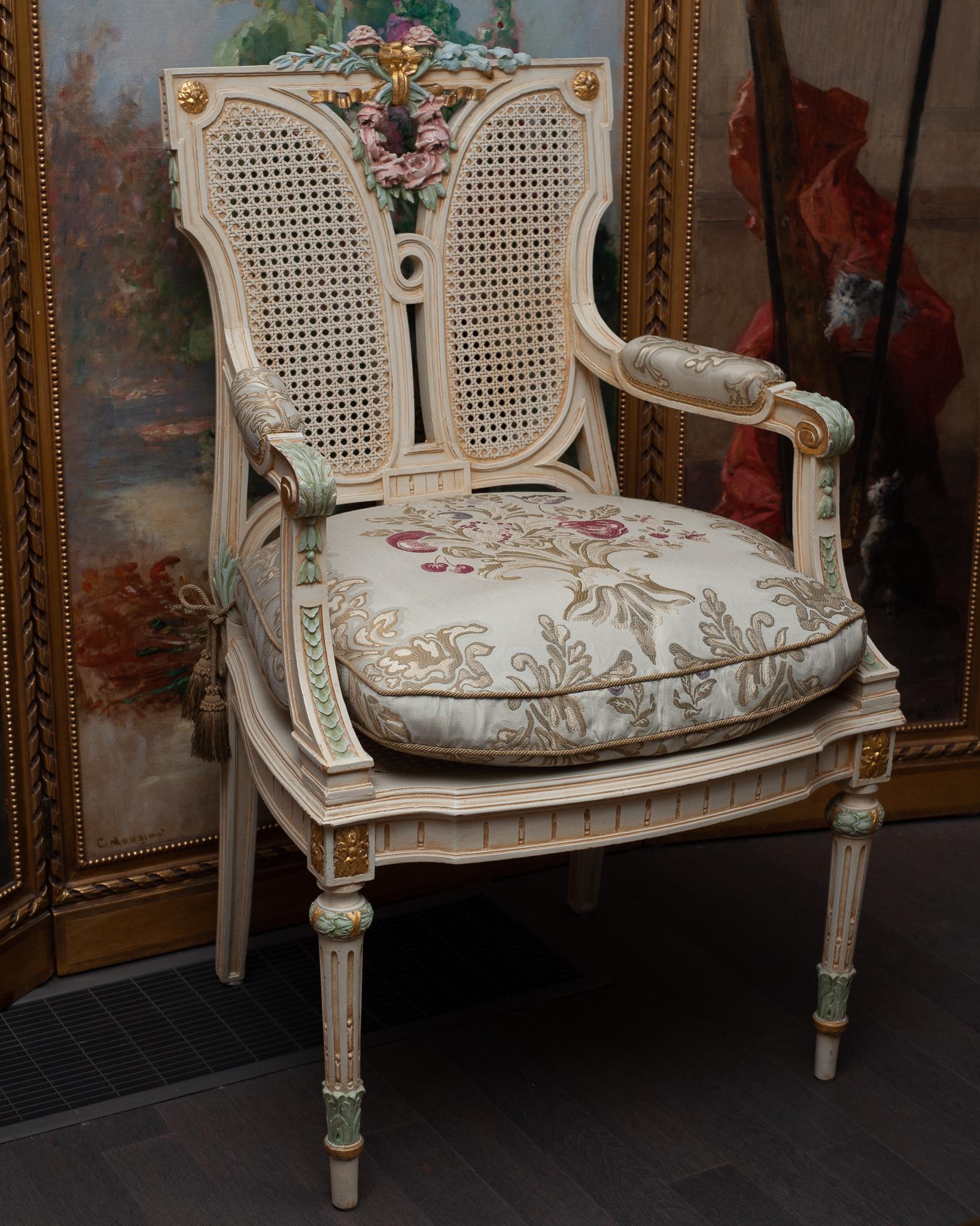 A stunning carved antique French hand painted chair, reupholstered with brocade fabric and metallic trim. Fully panelled in woven cane webbing through the back and seat. Hand carved and painted, the fine craftsmanship of this piece is what makes