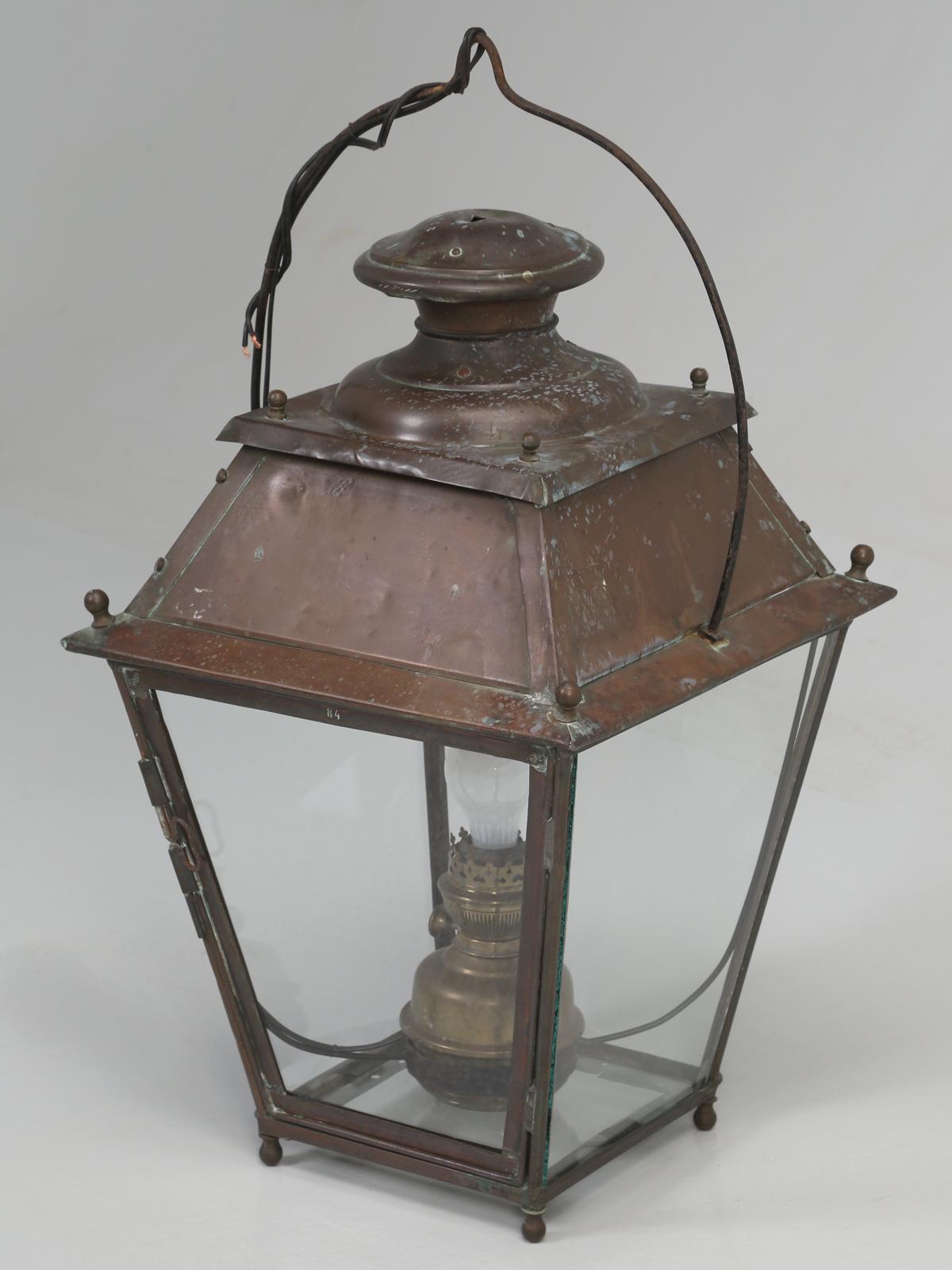 Antique French Copper Lantern, old enough to have been originally lite by kerosene. The Antique French Copper Lantern, has been converted to electricity and we can adapt it to use, either a candelabra bulb, or leave as is, for a standard size bulb.