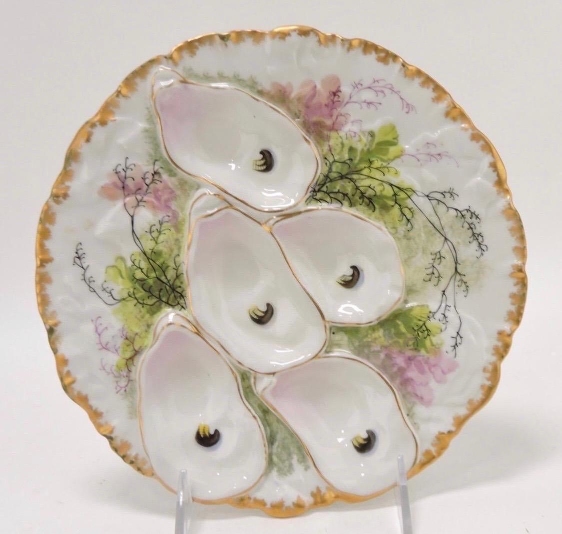 The antique Haviland & Company Limoges Turkey Pattern Oyster Plate is a beautiful and collectible piece of porcelain tableware produced by the renowned French manufacturer Haviland, known for its fine craftsmanship and luxurious designs. This