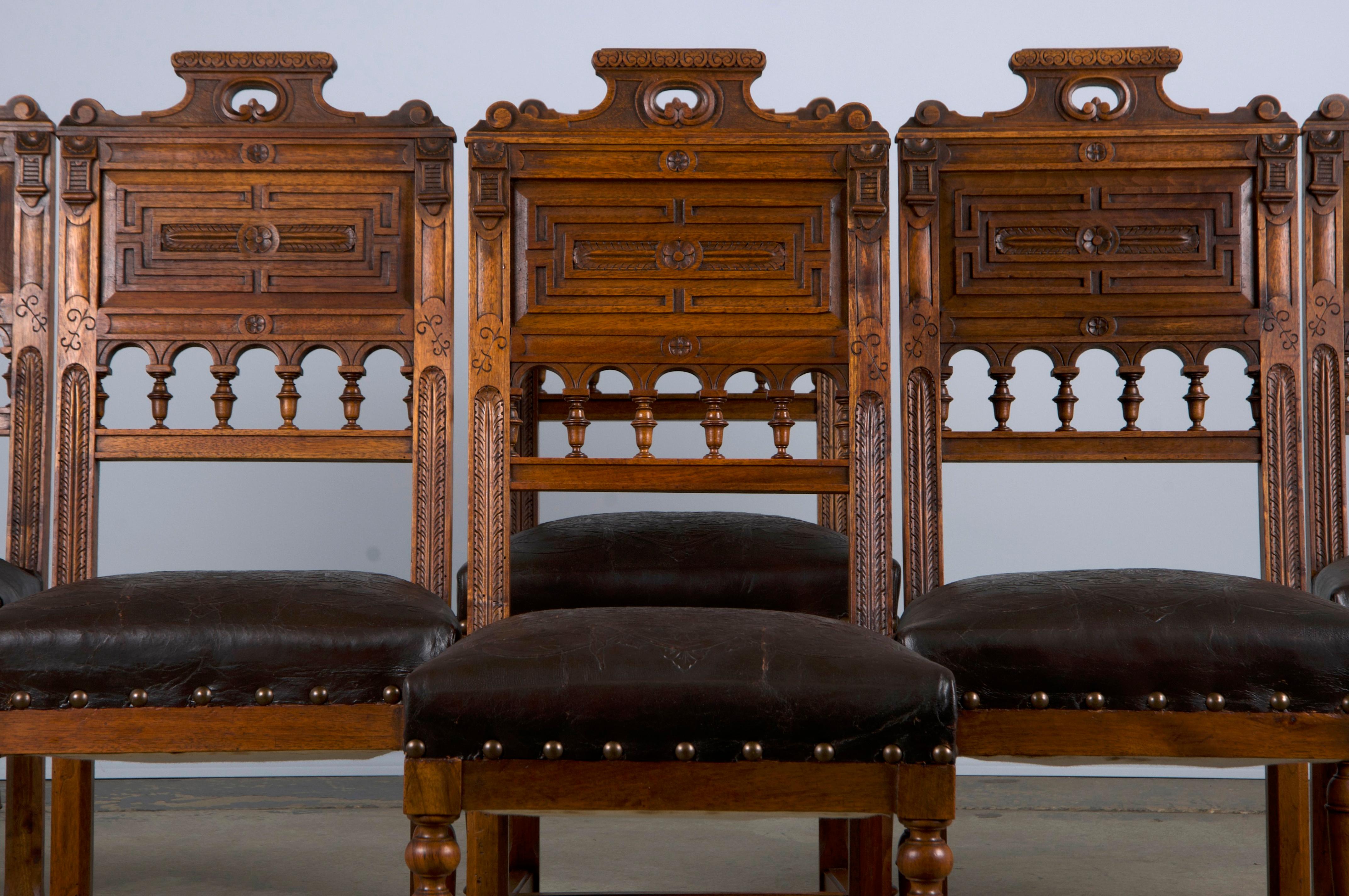 An exquisite 19th-century set of six French dining chairs made in the style of Henry II, sourced from Provence, France. Beautifully hand-crafted from solid walnut wood featuring intricately hand-carved back frames showcasing a naturally aged patina