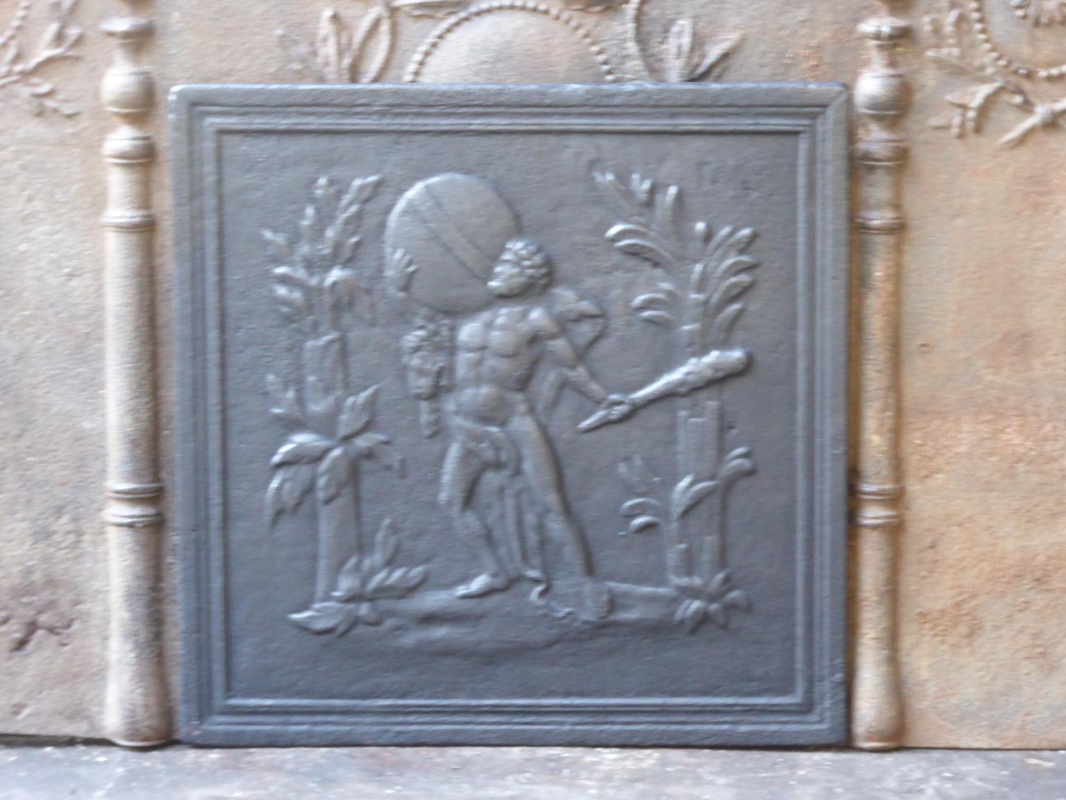 18th-19th century French neoclassical fireback. Hercules has Heaven in his arms, in exchange for the golden apples that atlas promises to deliver.

The fireback is made of cast iron and has a black / pewter patina. The fireback is in a good