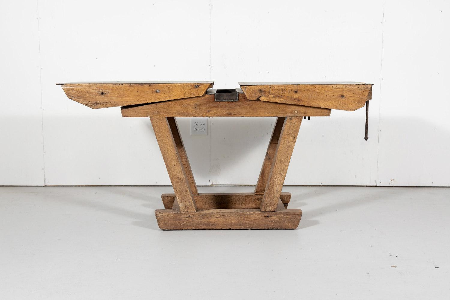 Antique French industrial workbench in chestnut having an iron top with a removable recessed grease trap and a traditional trestle base, circa early 1900s. Instantly add an Industrial flare to your space when used as console table, kitchen island,