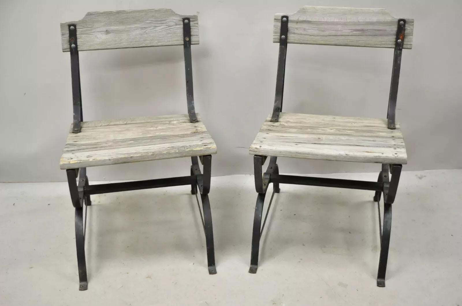 Antique French Industrial Wrought Iron Wooden Slat Seat Side Chairs - a Pair. Item features a wood slat seat and back, wrought iron construction, wooden stretcher base, distressed finish, very nice antique item, great style and form. Circa Early