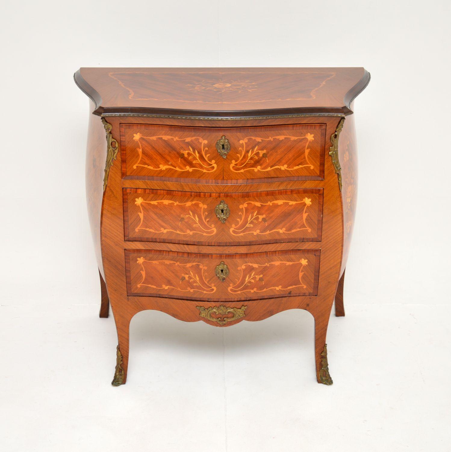 An absolutely stunning antique French bombe commode, dating from around the 1900-1910 period.

This is of superb quality, a great shape and it is a very useful size. There is profuse inlaid floral patterns of various woods throughout, and very high