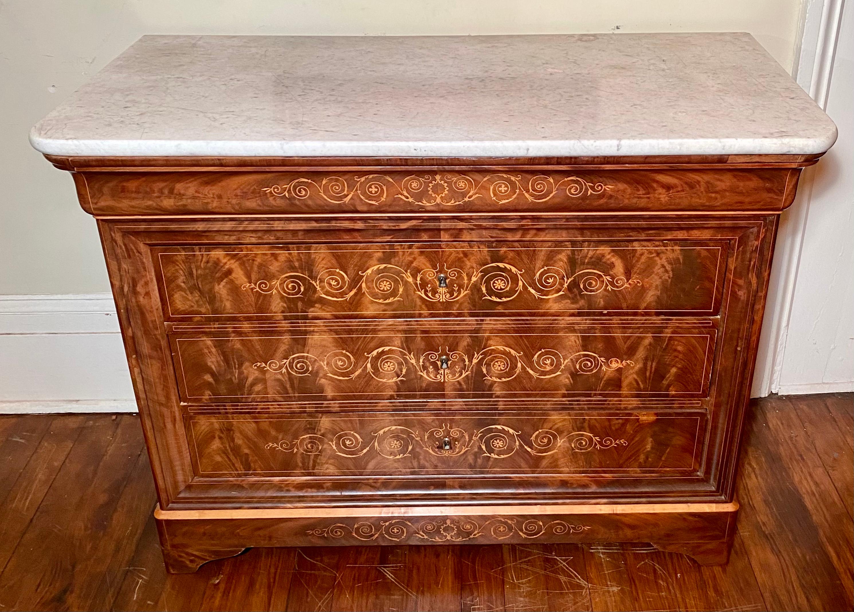 This commode has a marble top and is crafted of beautiful flame mahogany.

  