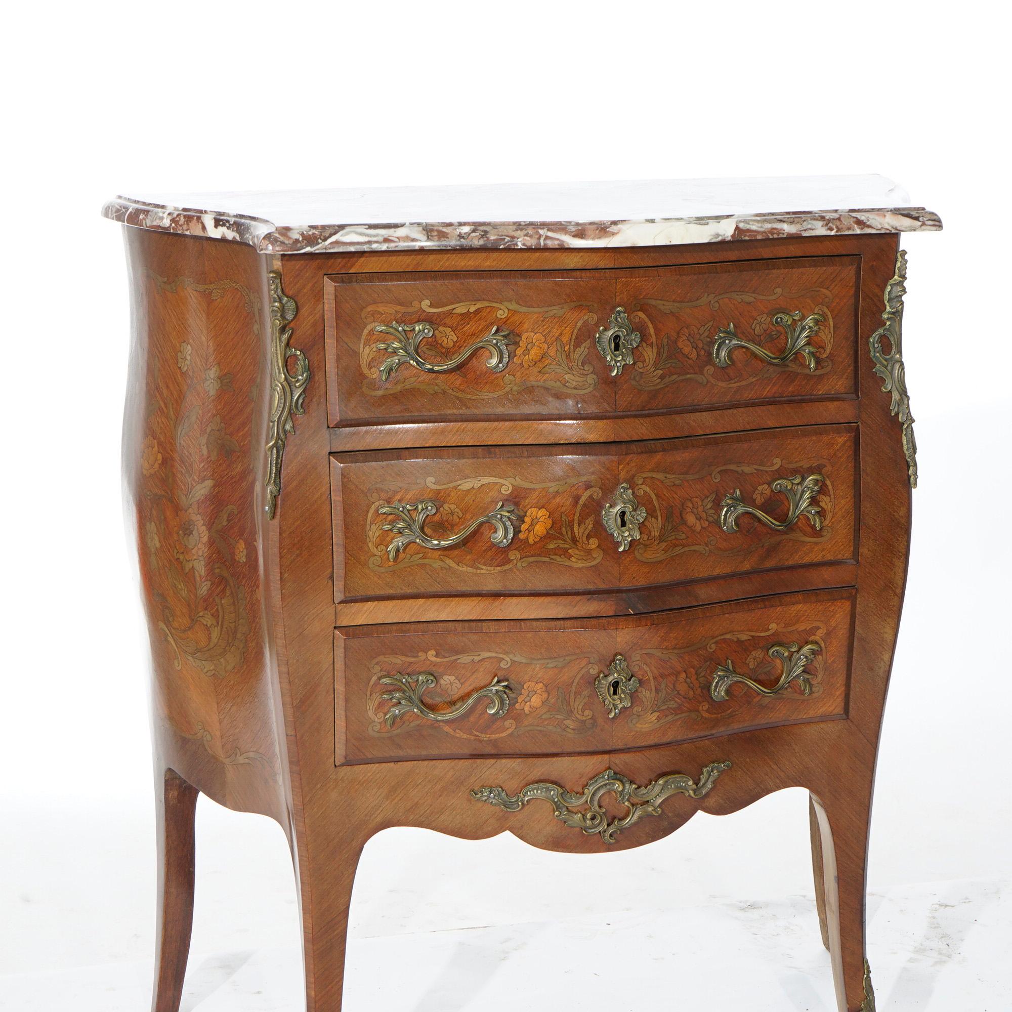 An antique French Louis XVI style bombe commode offers shaped and beveled marble top over kingwood and rosewood three drawer base having marquetry decoration throughout, cast foliate ormolu and raised on cabriole legs, c1910

Measures- 33.5''H x