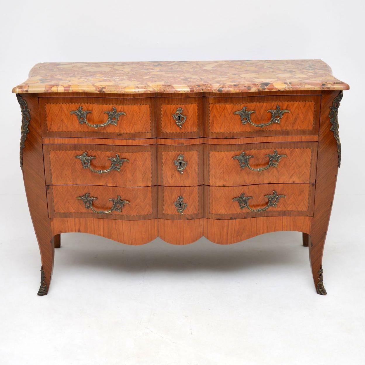 Very impressive antique French marble-top commode with a wonderful shape and a fitted secretaire writing compartment within the dummy top drawer. I’ve never come across a shaped commode like this with a secretaire inside. It has a very colorful and