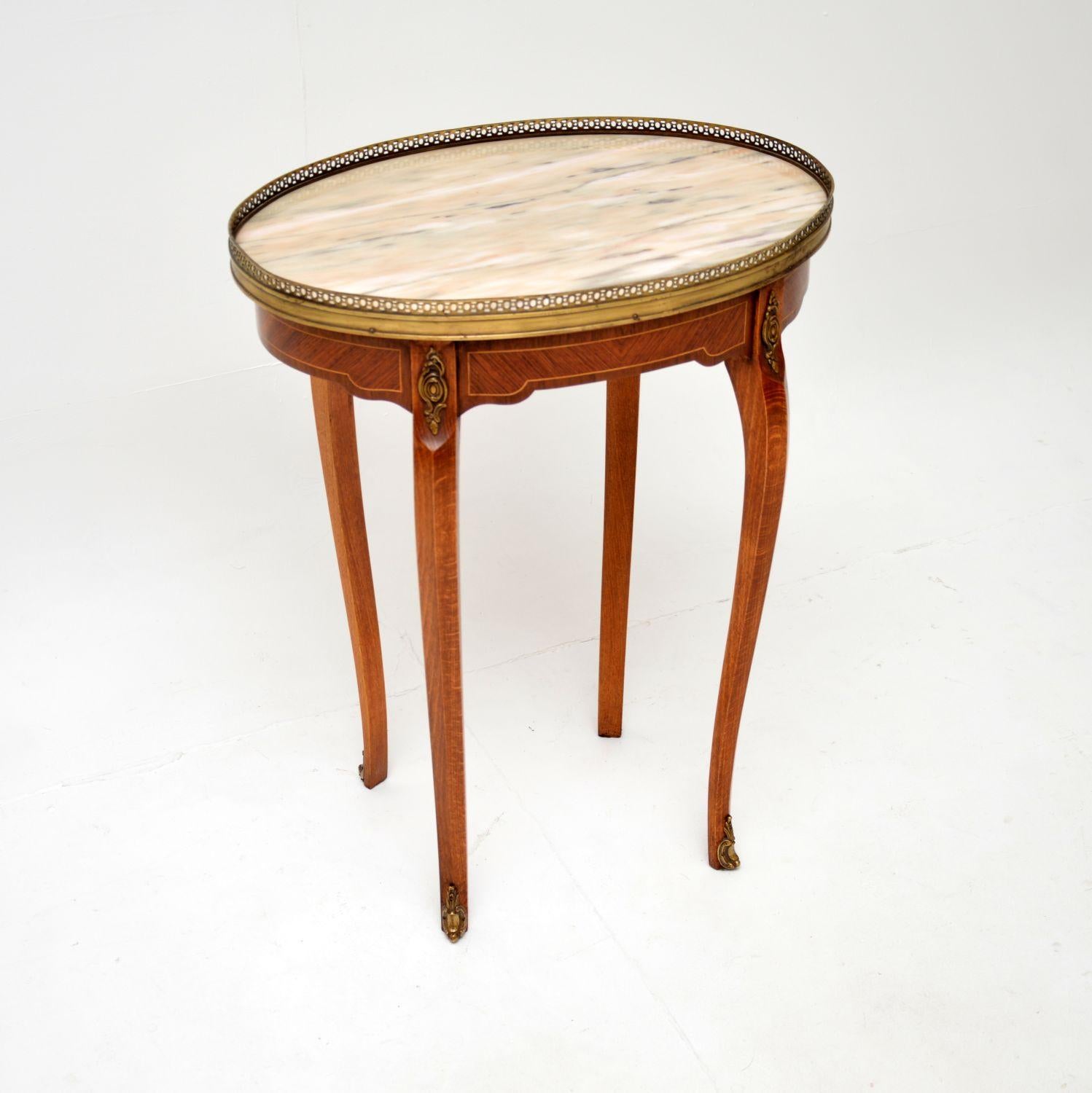 A beautiful antique French inlaid marble top side table, dating from around the 1930’s.

This is of superb quality and is a very useful size. The oval top is inlaid on all sides, meaning it can be used as a free standing item. There is a single