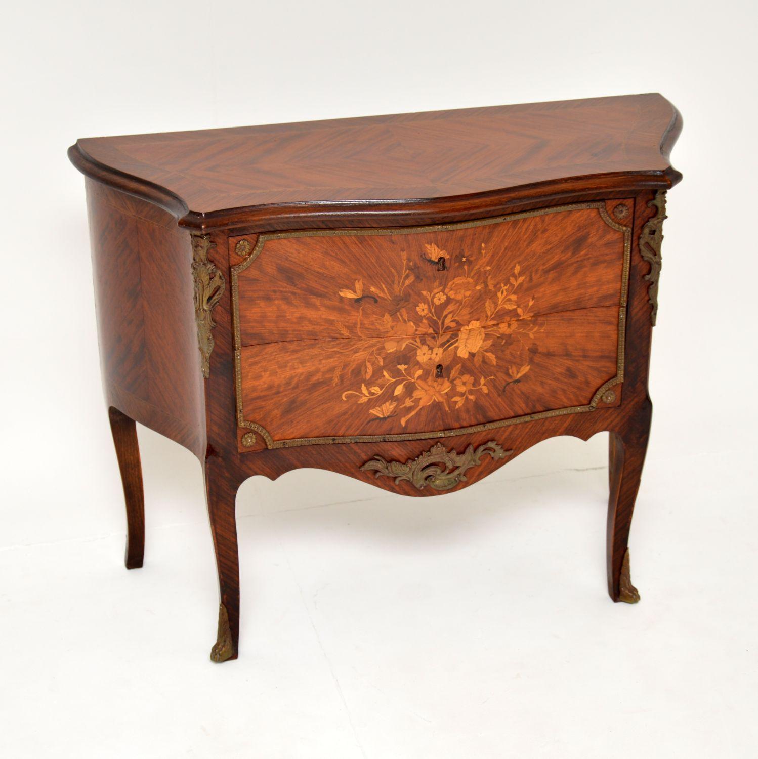 A beautiful antique French bombe chest, made from a stunning variety of woods, dating from around the 1930’s.

It is of superb quality and is a lovely, compact size. The front and sides have a curvaceous, serpentine design, there are high quality