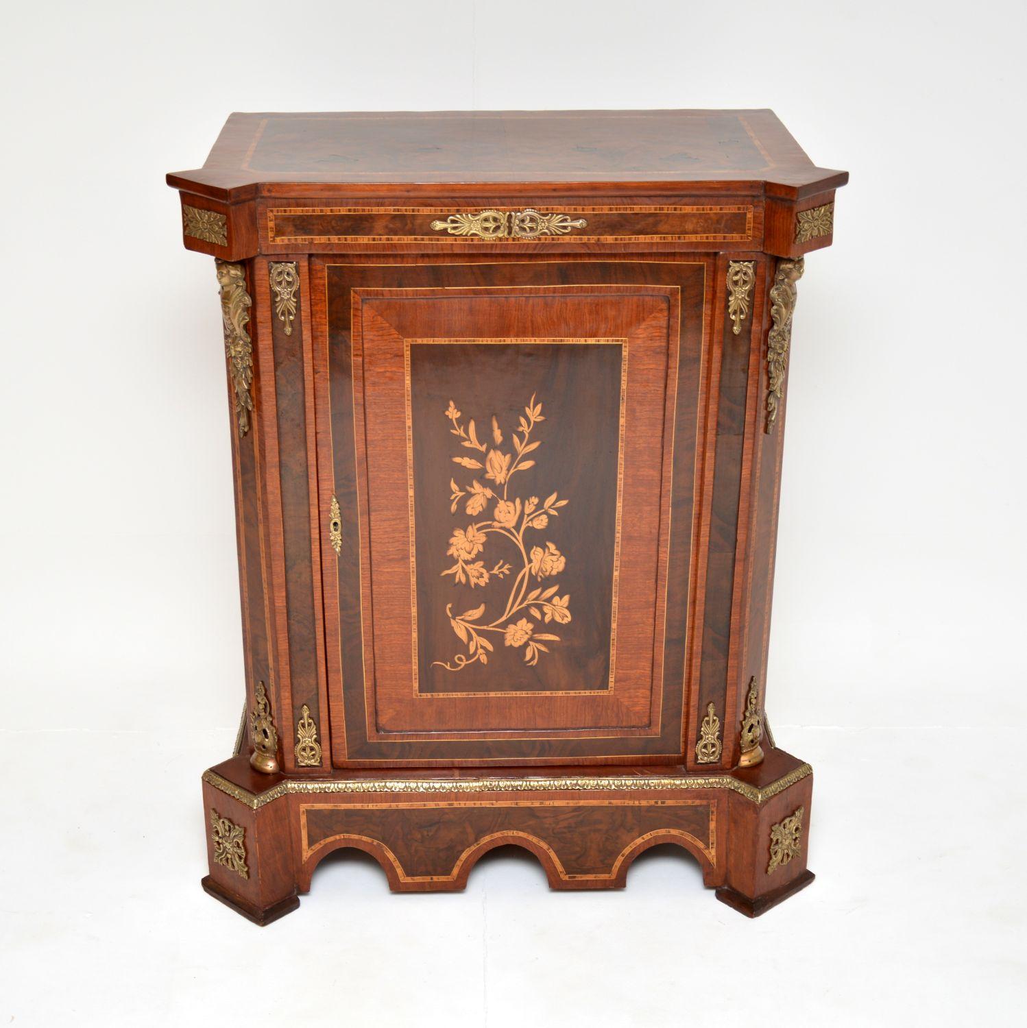A beautiful and impressive antique cabinet. I would say it’s French and dates from around the 1930-50’s period.

It has gorgeous inlaid floral designs and nice ormolu mounts throughout. It has an impressive shape and is of lovely proportions.

We